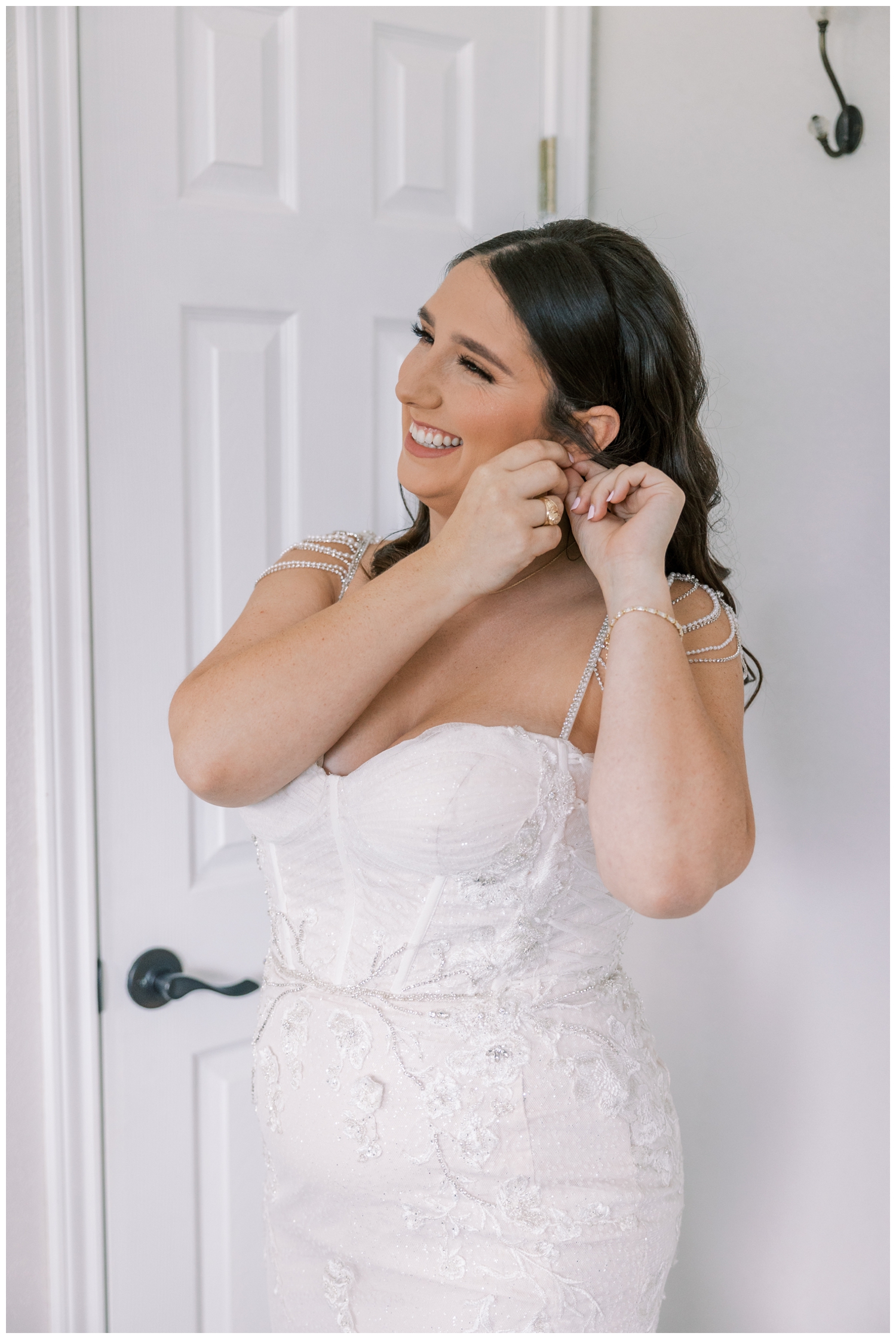 bride getting ready and putting on earrings inside Bluebird Haven Estates Wedding venue
