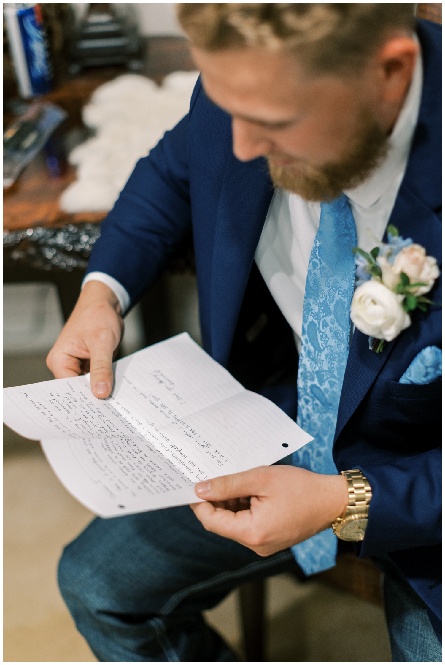 groom sitting and reading love letter from bride