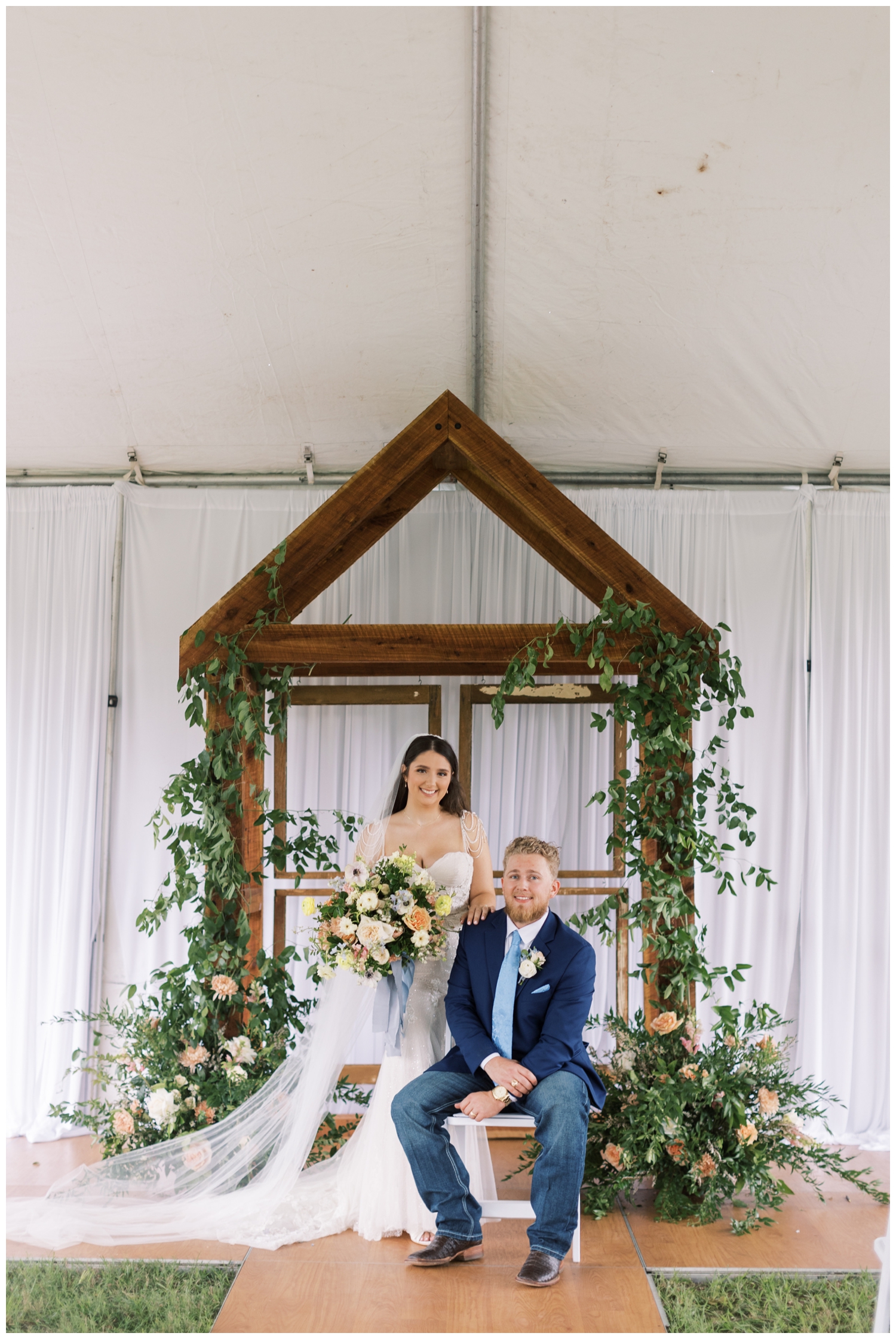 bride and groom portrait sitting under a tent