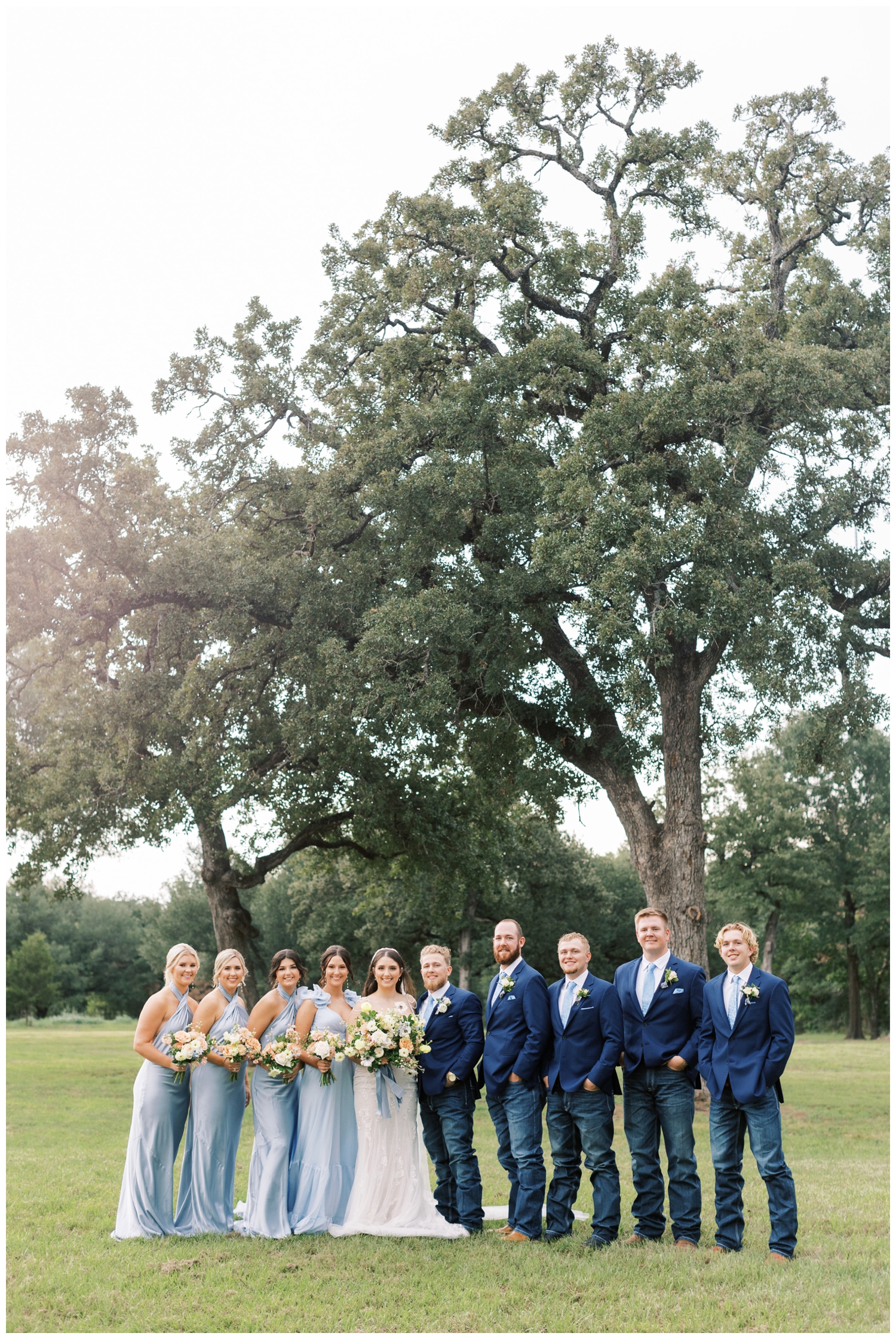 wedding party standing in a line in blue colors