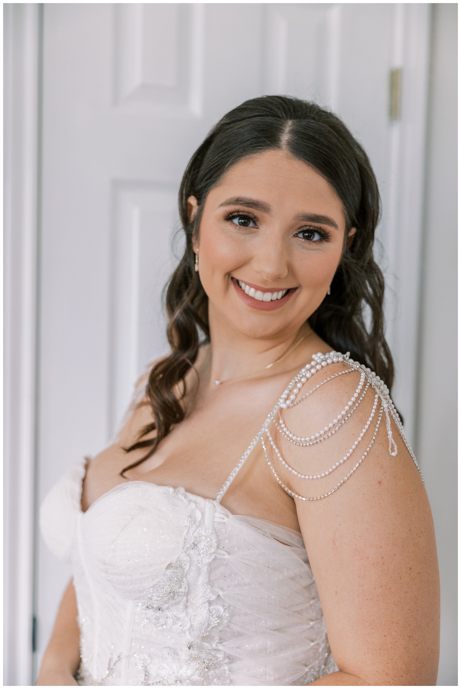 close up bridal portrait by a white wall inside Bluebird Haven Estates