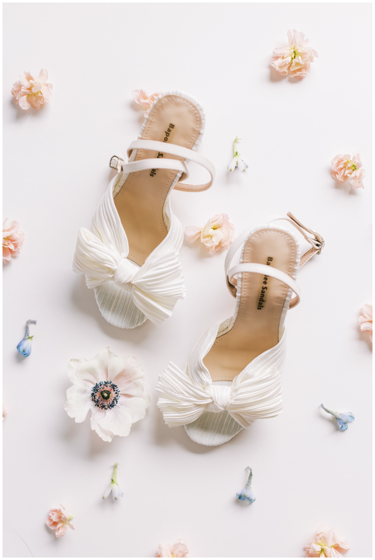 white wedding heels surrounded by white floral at Bluebird Haven Estates Wedding venue