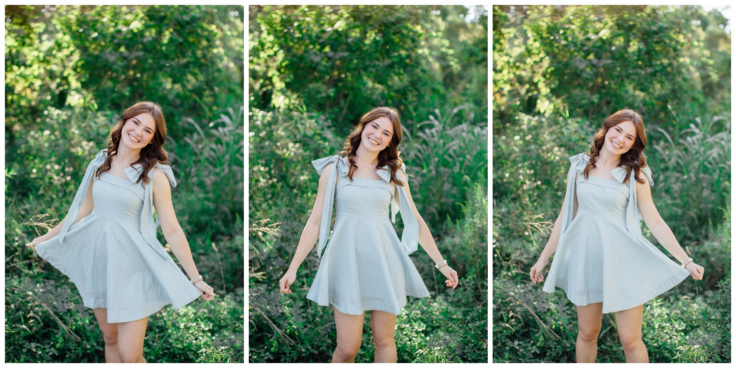 high school senior girl in light blue dress twirling in a field for fall senior photos Houston