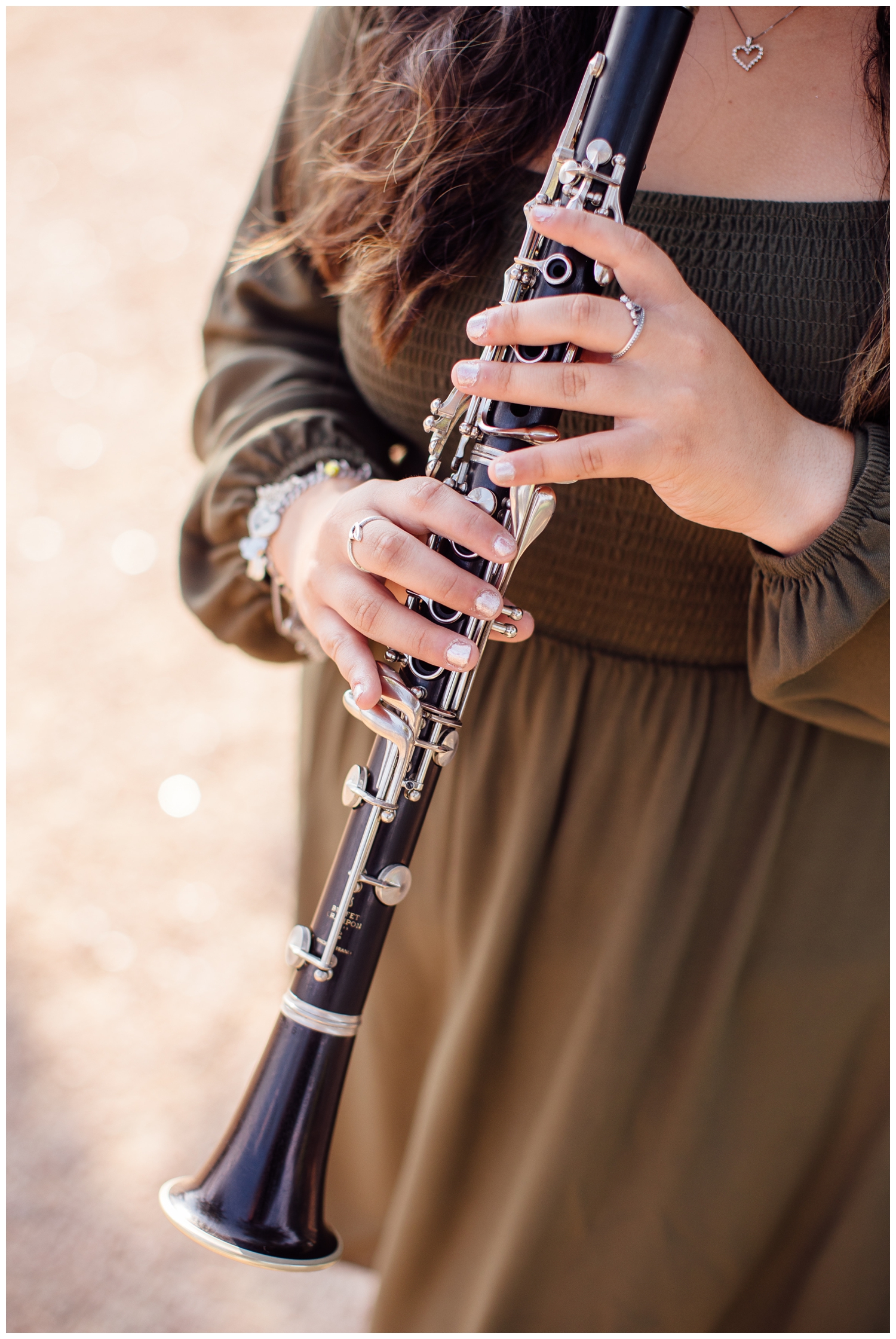 closeup image of girls hands playing clarinet for Senior Photos in Houston