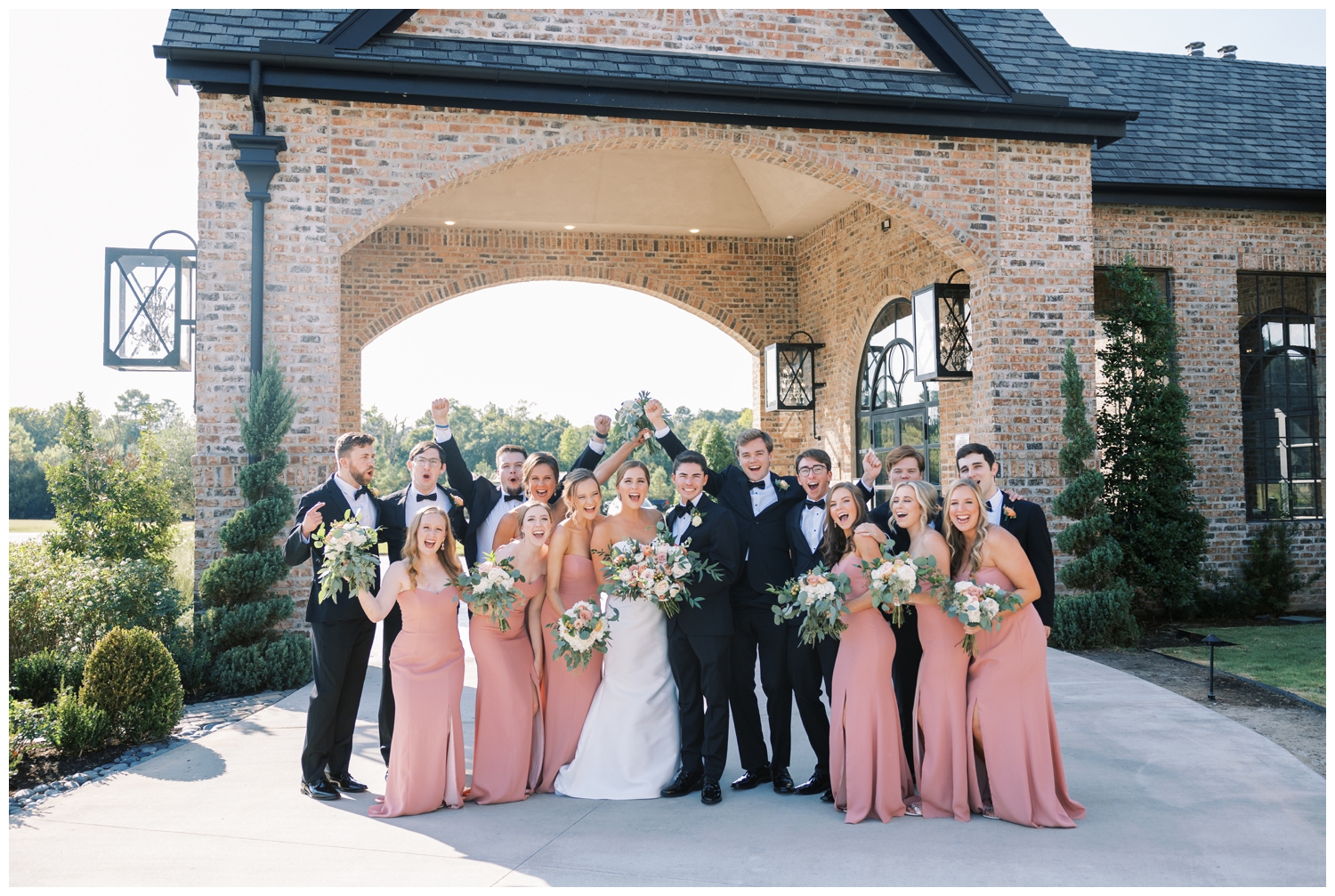 full wedding party smiling and laughing for elegant Iron Manor Wedding