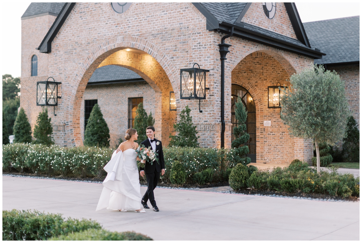 newlyweds holding hands and walking outside Iron Manor Wedding Venue