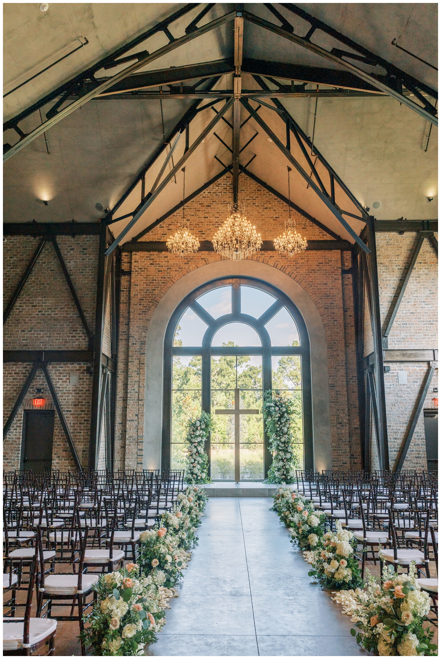 cross with floral arch inside Iron Manor ceremony space