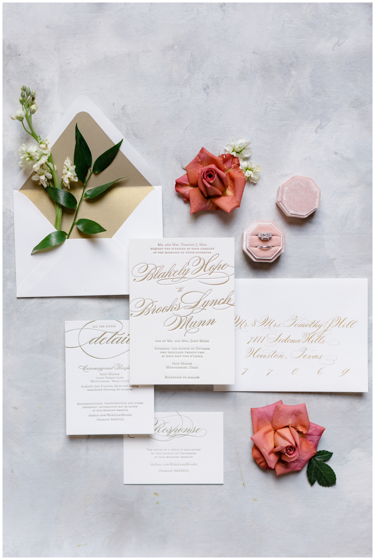 flat lay white invitation suite with coral florals