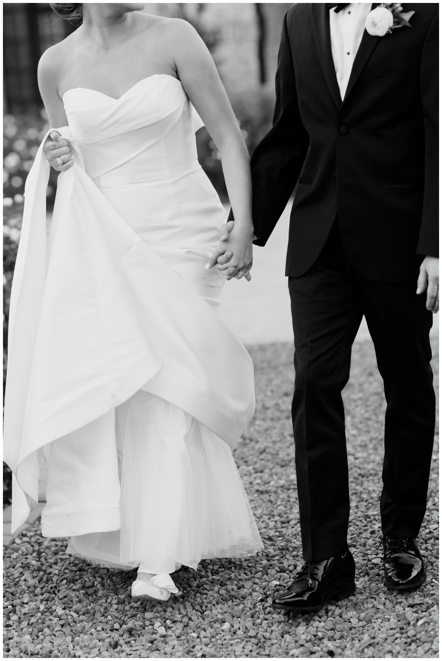 black and white detailed image of bride and grooms hands