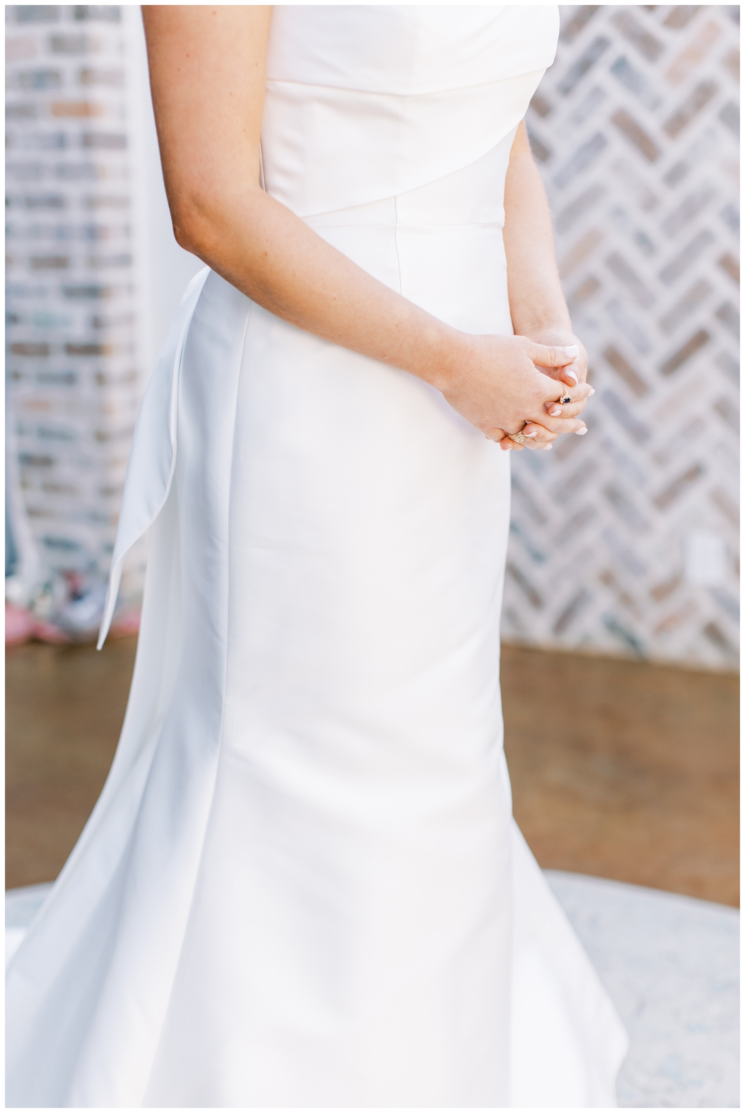 detailed image of bride in wedding gown with hands folded