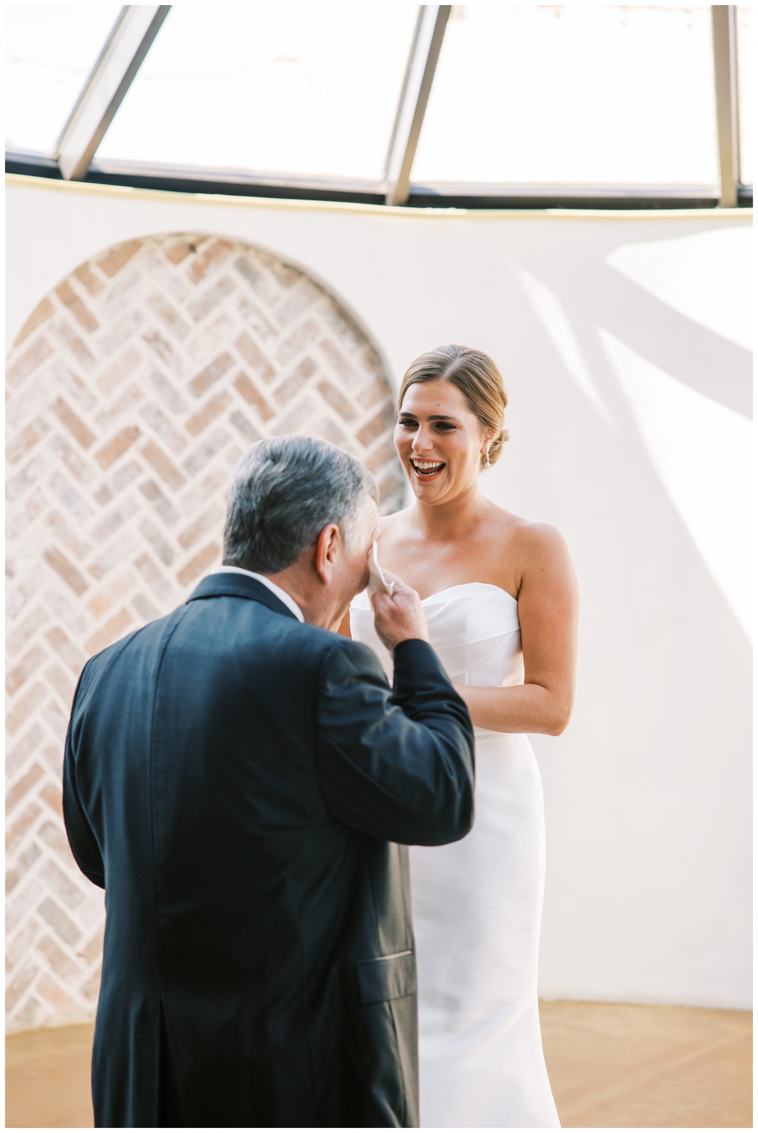father wiping tears away during first look with bride elegant Iron Manor Wedding