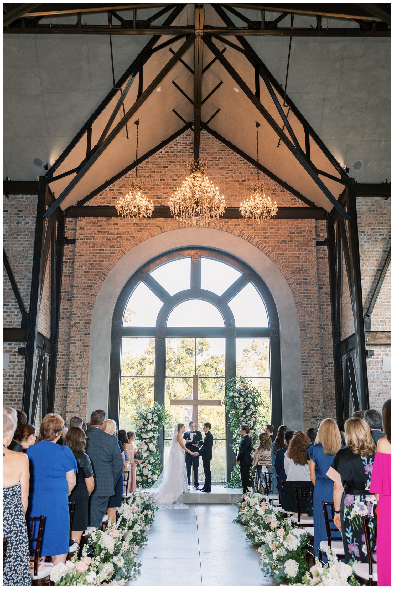 ceremony space with bride and groom in front of cross