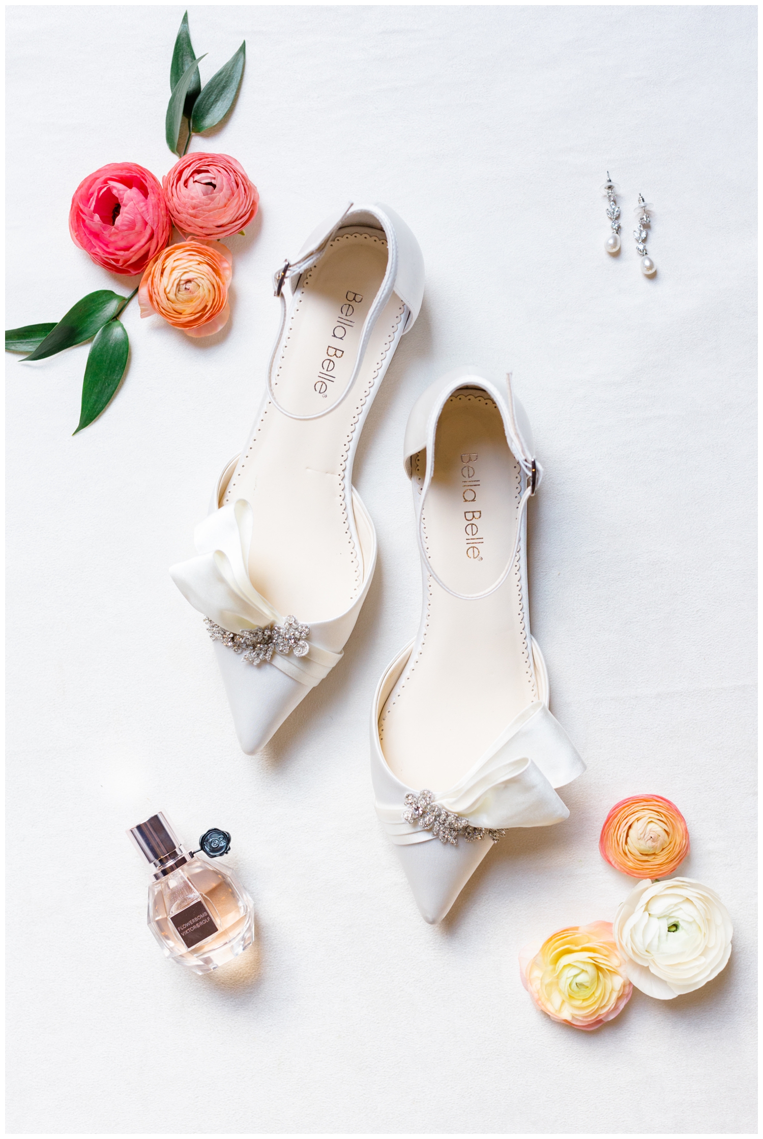 detailed image of white wedding heels surrounded by florals