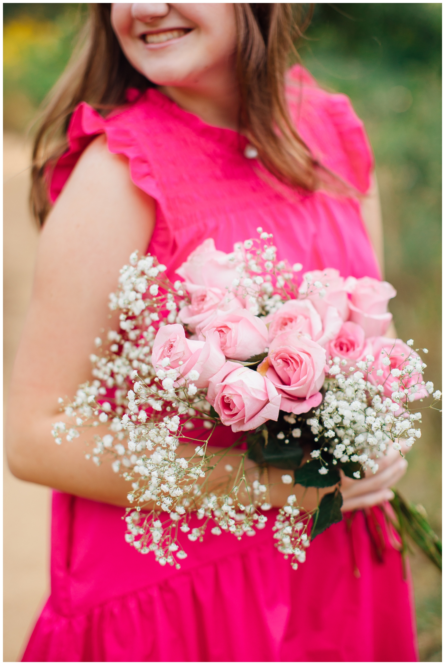 Houston senior photos with flowers girl in hot pink dress