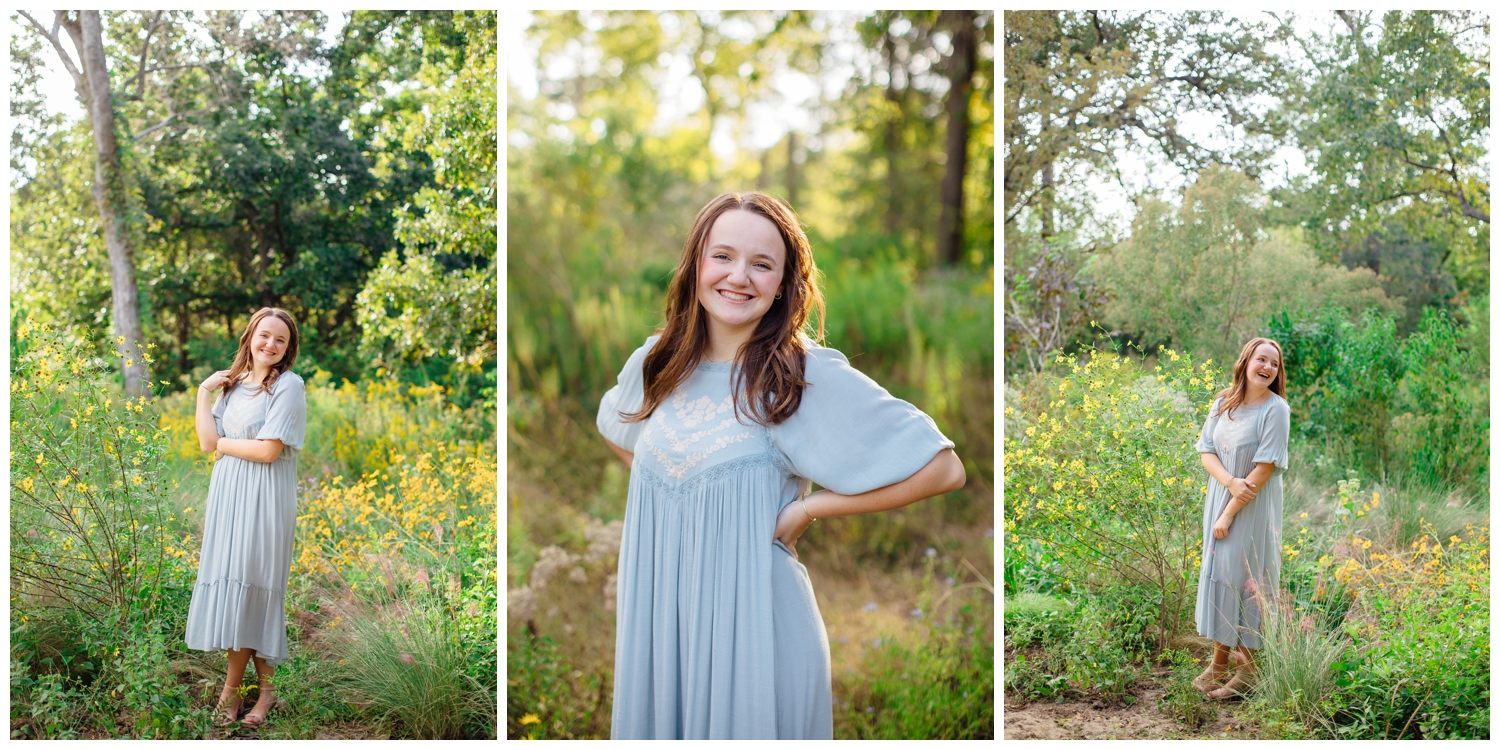 girl in blue dress standing in a field for Houston senior photos with flowers at Houston Arboretum