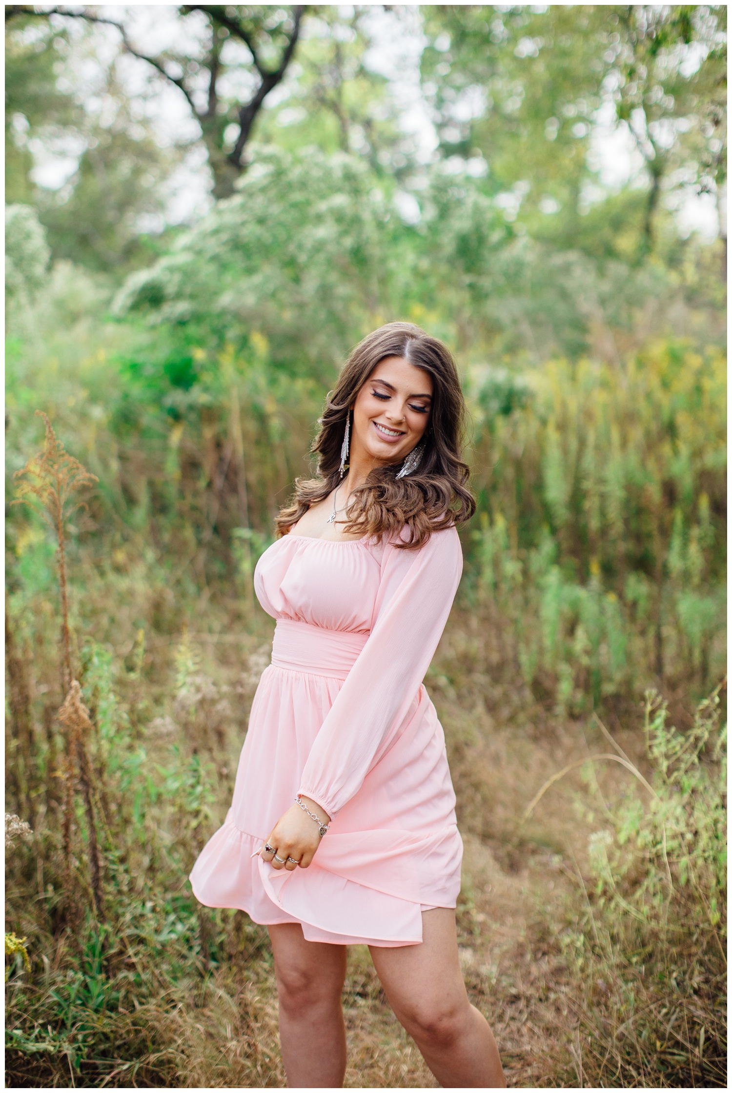 girl twirling blush pink dress in field Houston Texas