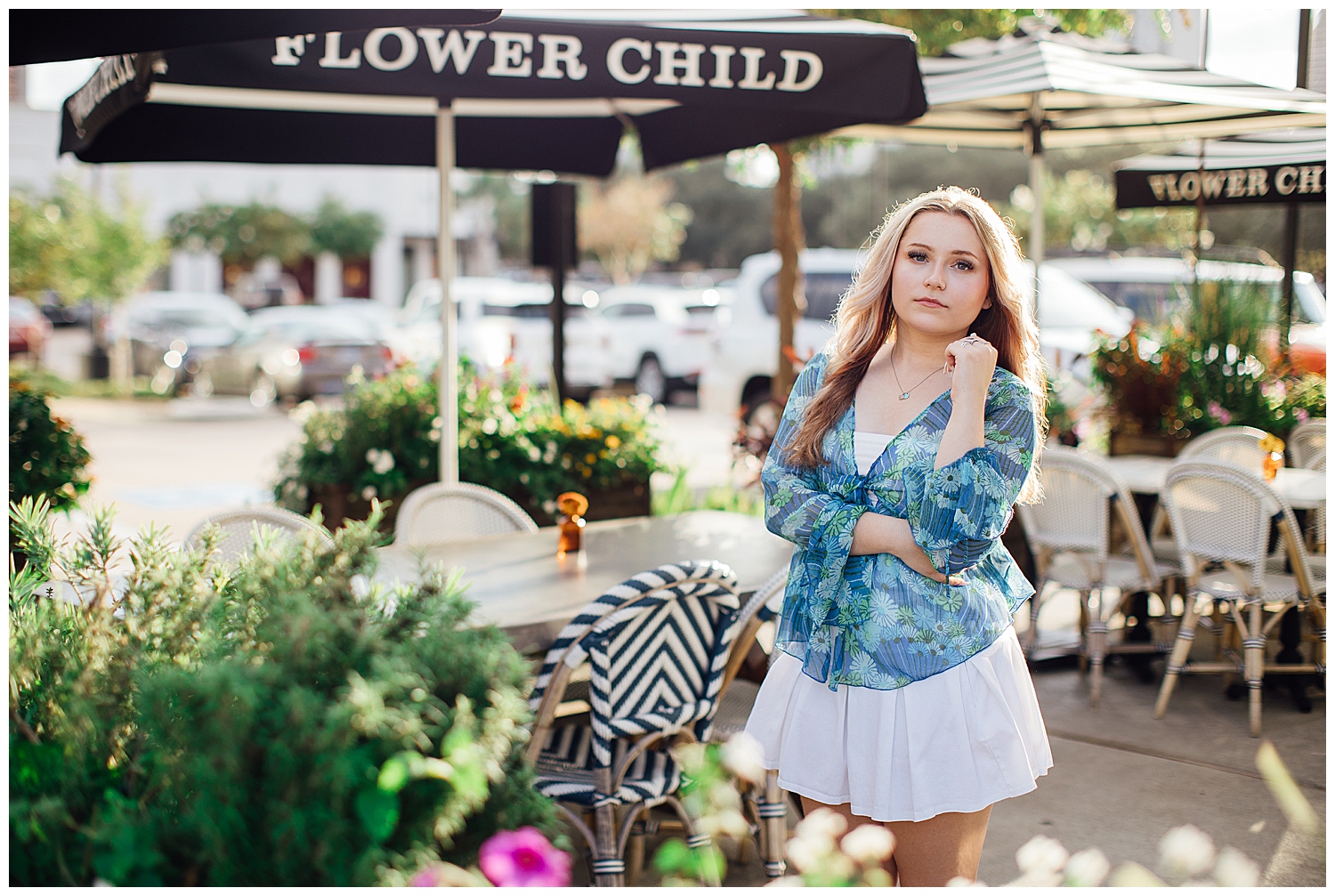 high school girl standing outdoors at Flower Child in Houston white skirt blue shirt