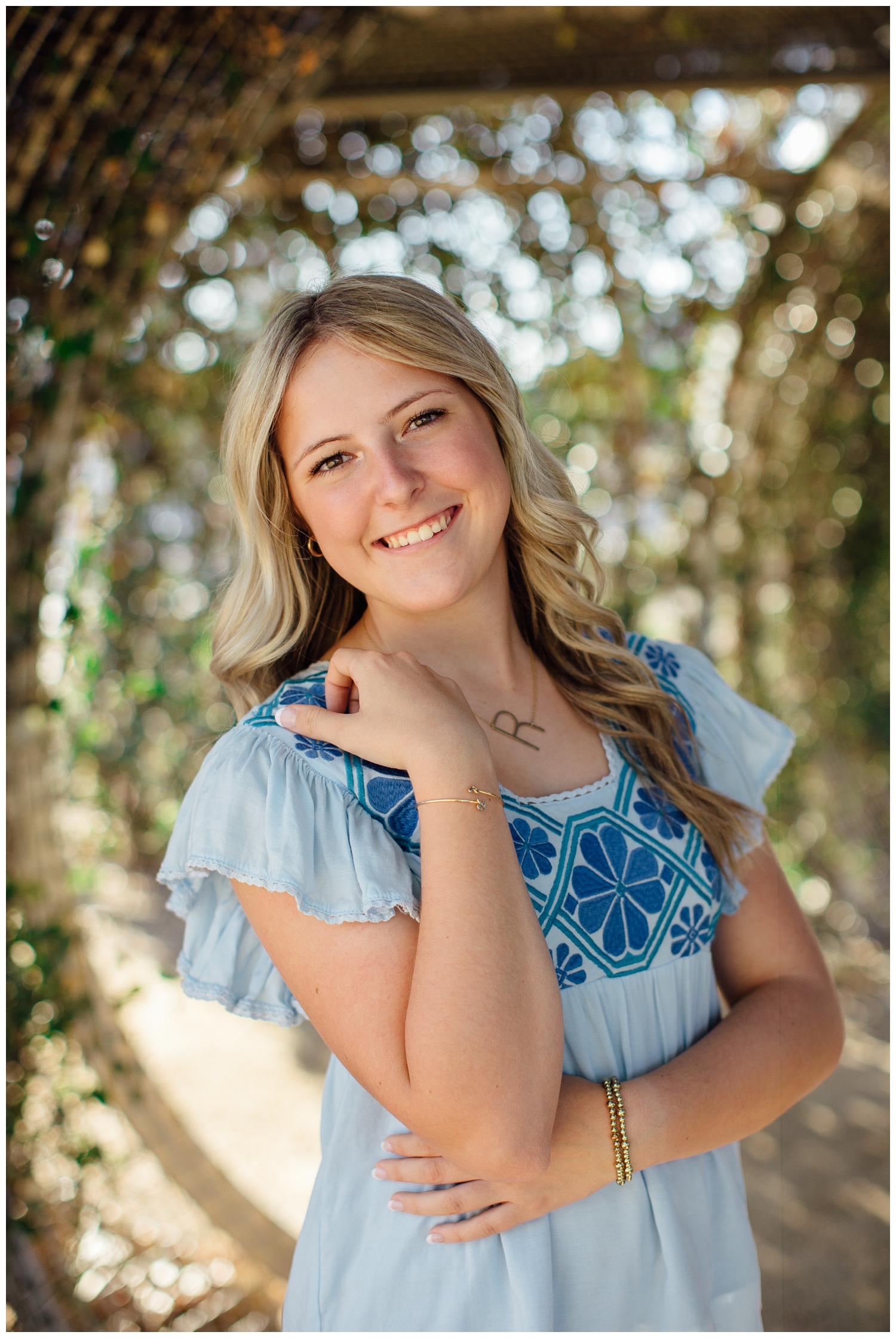 closeup portrait of girl in blue blouse with hand in hair for Outdoor Houston senior photography