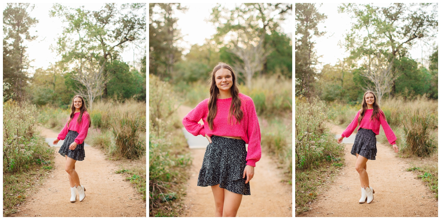 high school senior girl in hot pink shirt and black skirt standing on pathway at Senior Pictures Houston Arboretum