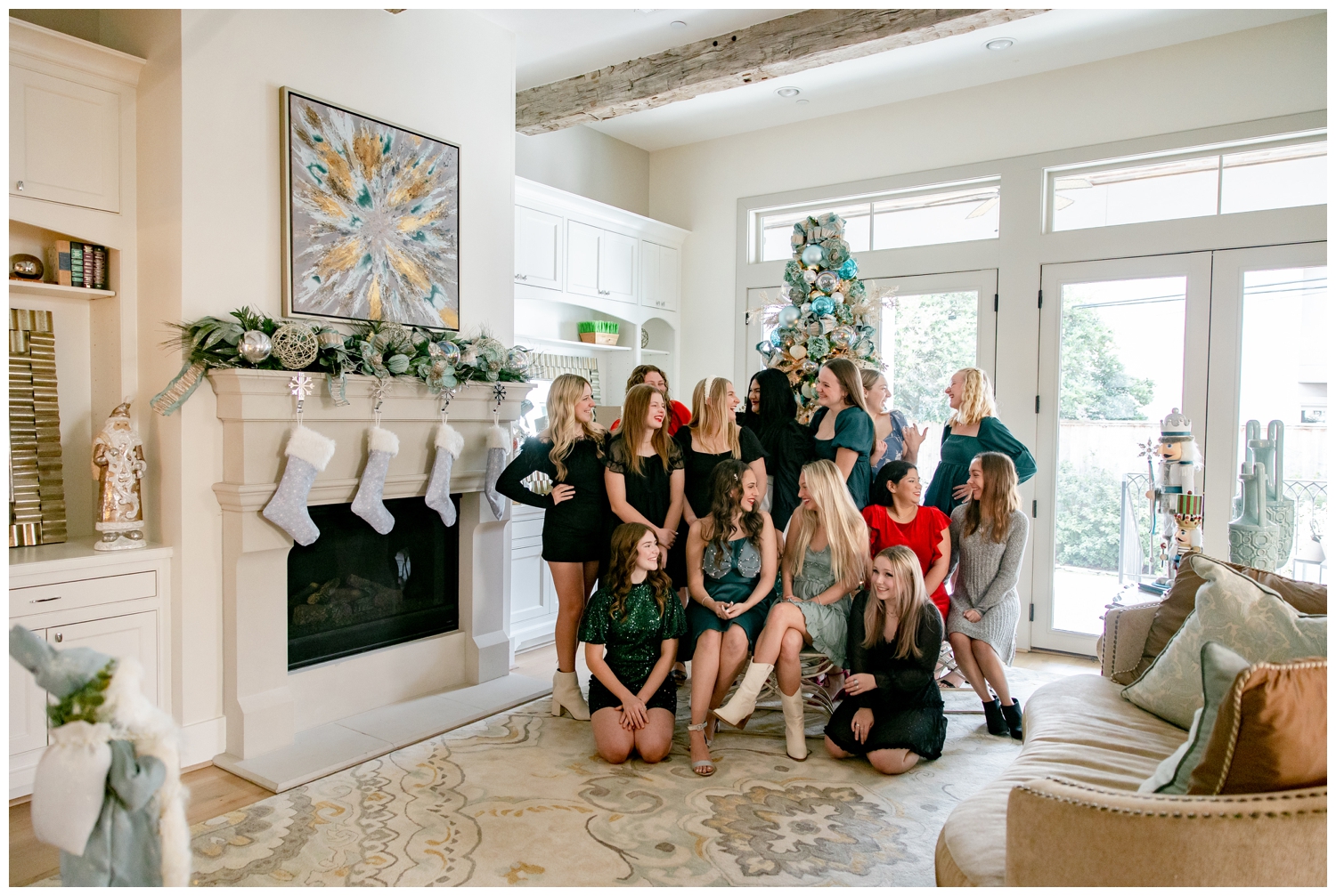 high school senior girls in dresses laughing in front of Christmas tree