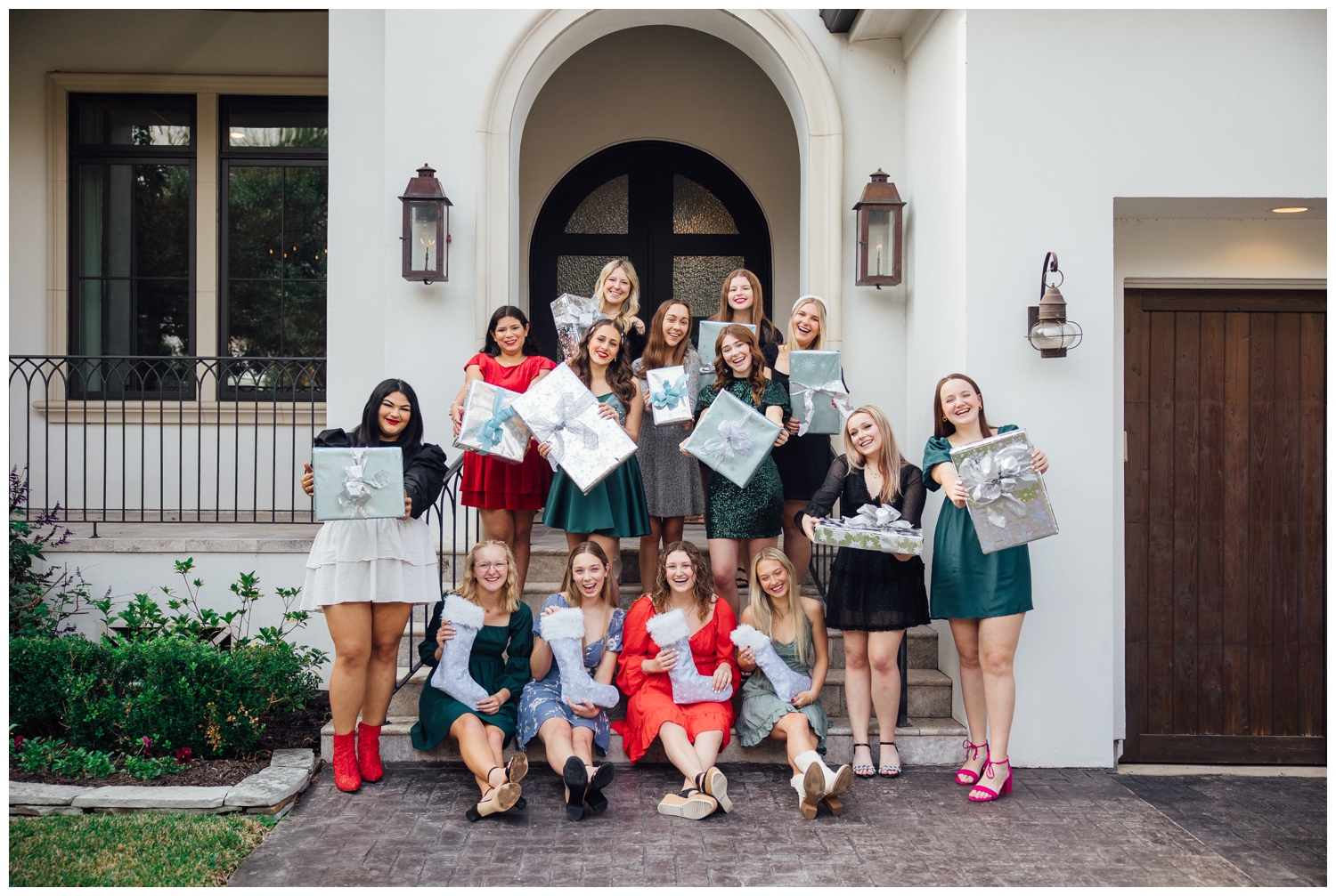 senior reps Christmas Photoshoot Houston with group of girls in dresses holding stockings and presents
