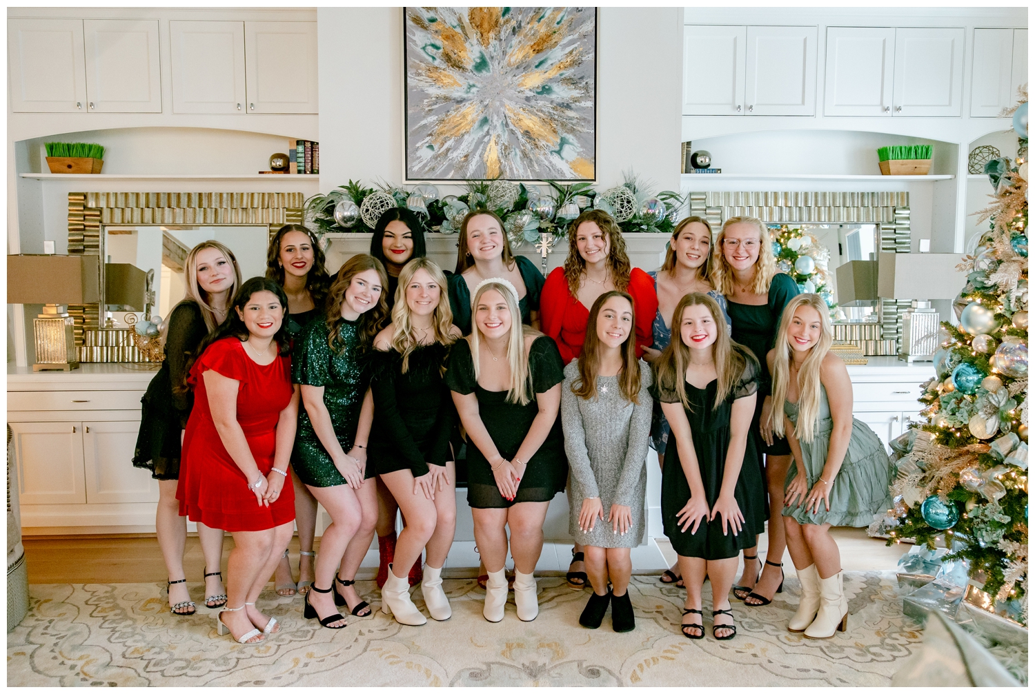 high school senior girls standing in front of gray mantle with Christmas decorations