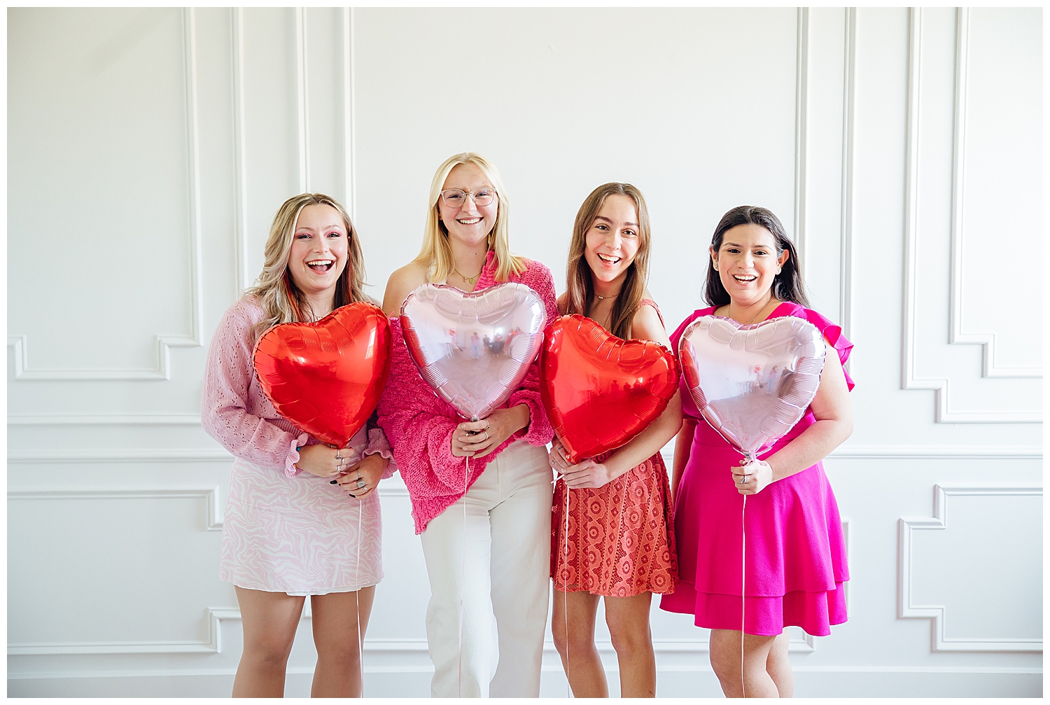 Valentine's Day Senior Photoshoot girls in pink holding heart balloon