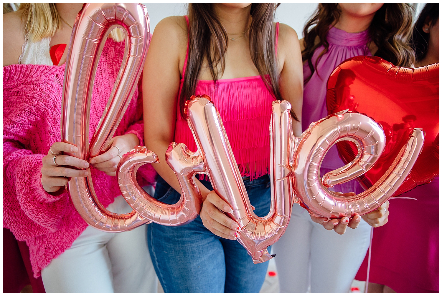 hands holding pink love balloon