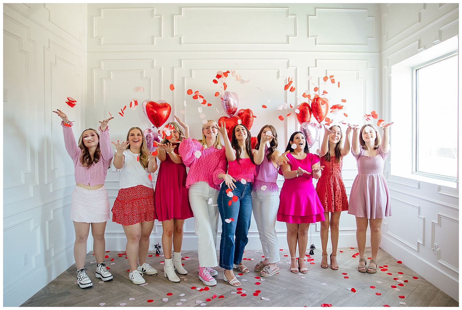 Reed Gallagher Photography senior rep team Valentine's Day Senior Photoshoot with girls throwing rose petals in a white studio