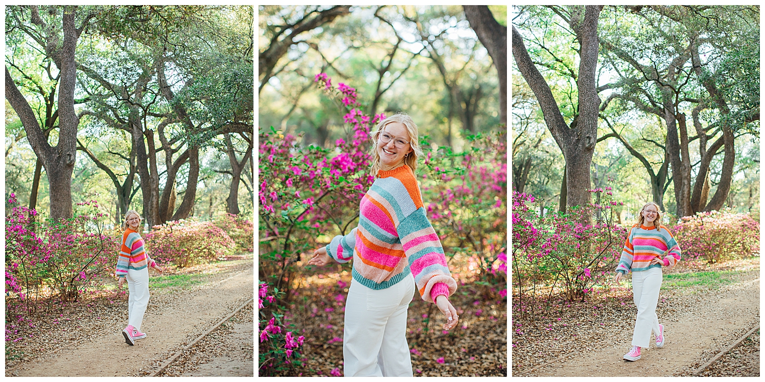 girl in white pants and pink, orange, blue sweater walking in Hermann Park for colorful Houston senior session
