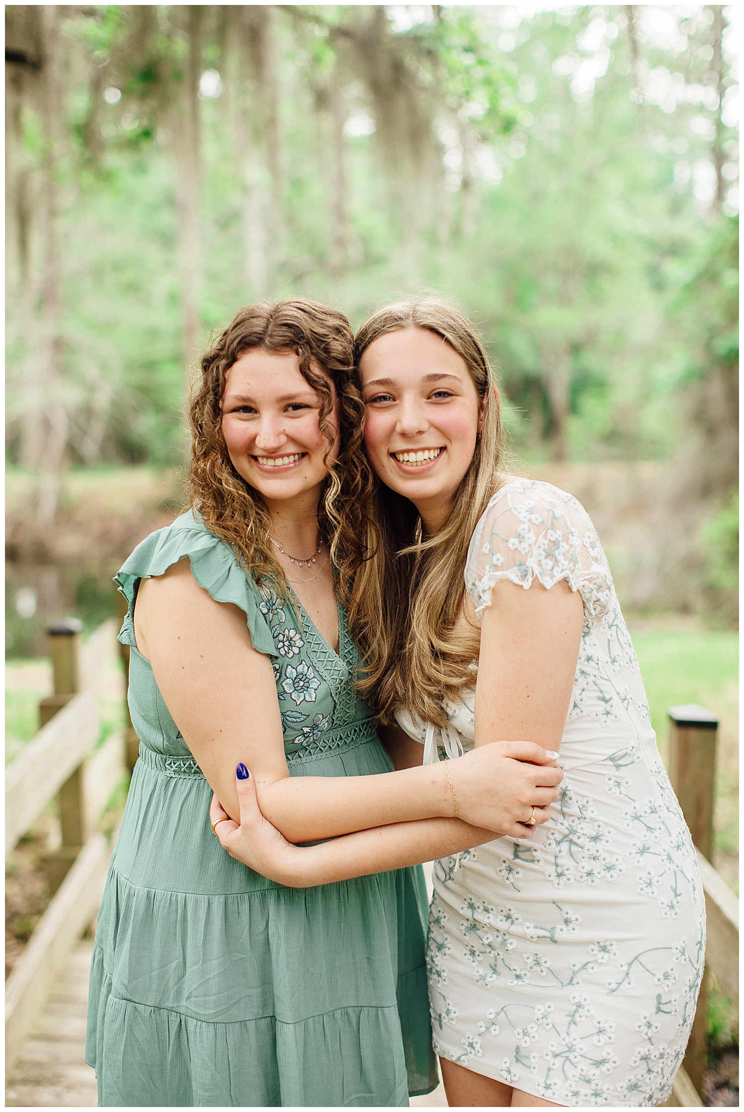 two senior girls standing and hugging outdoors at Cy Hope for best friends senior pictures