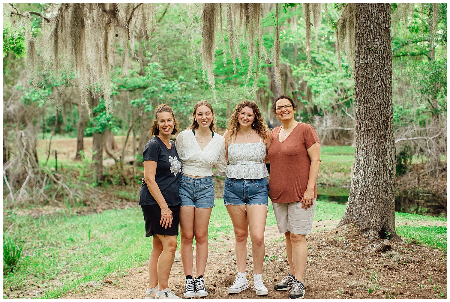 senior girls with their moms standing on a pathway in Houston for best friends senior pictures