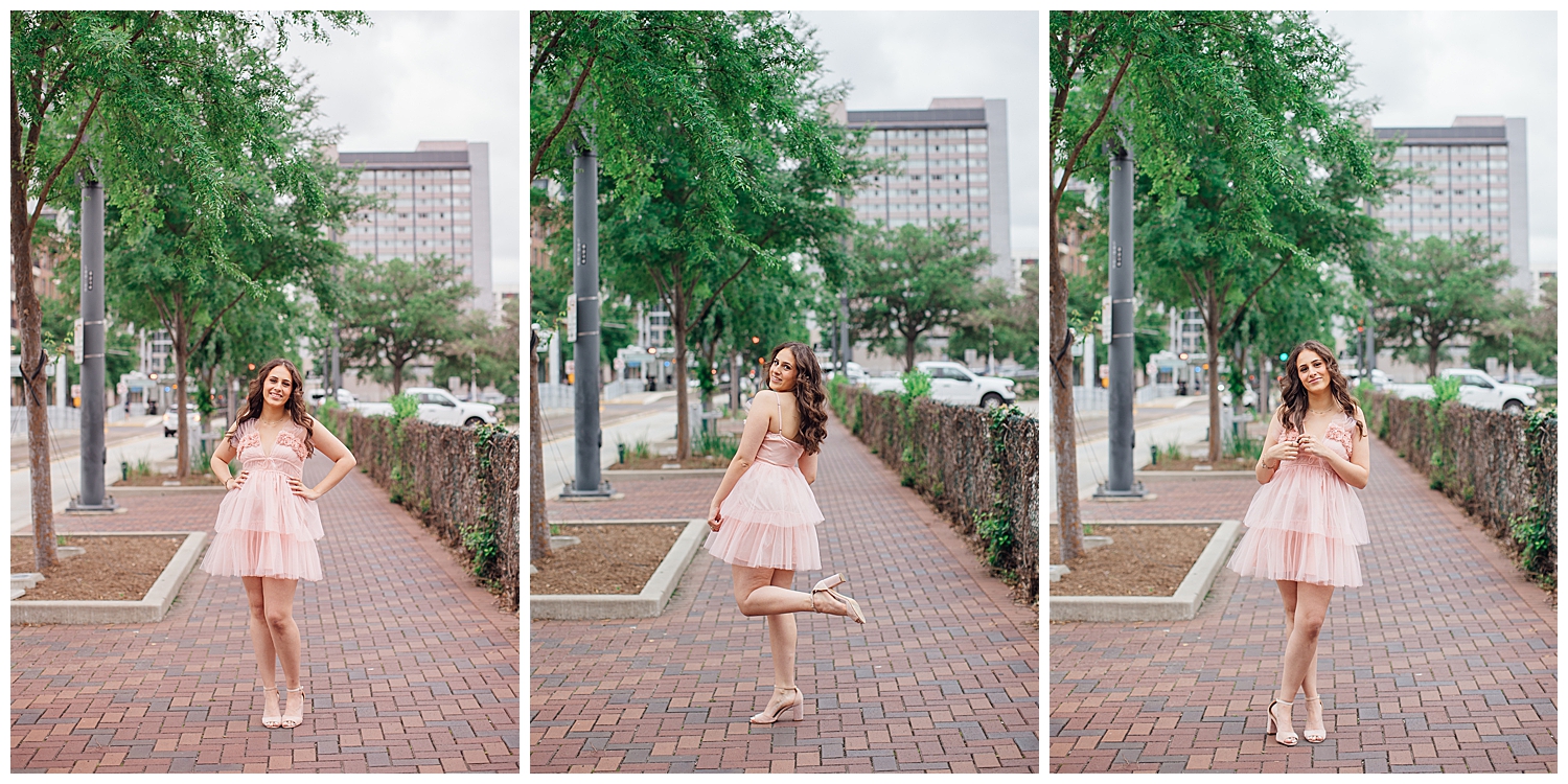 girl standing on Main Street downtown Houston in pink fluffy dress