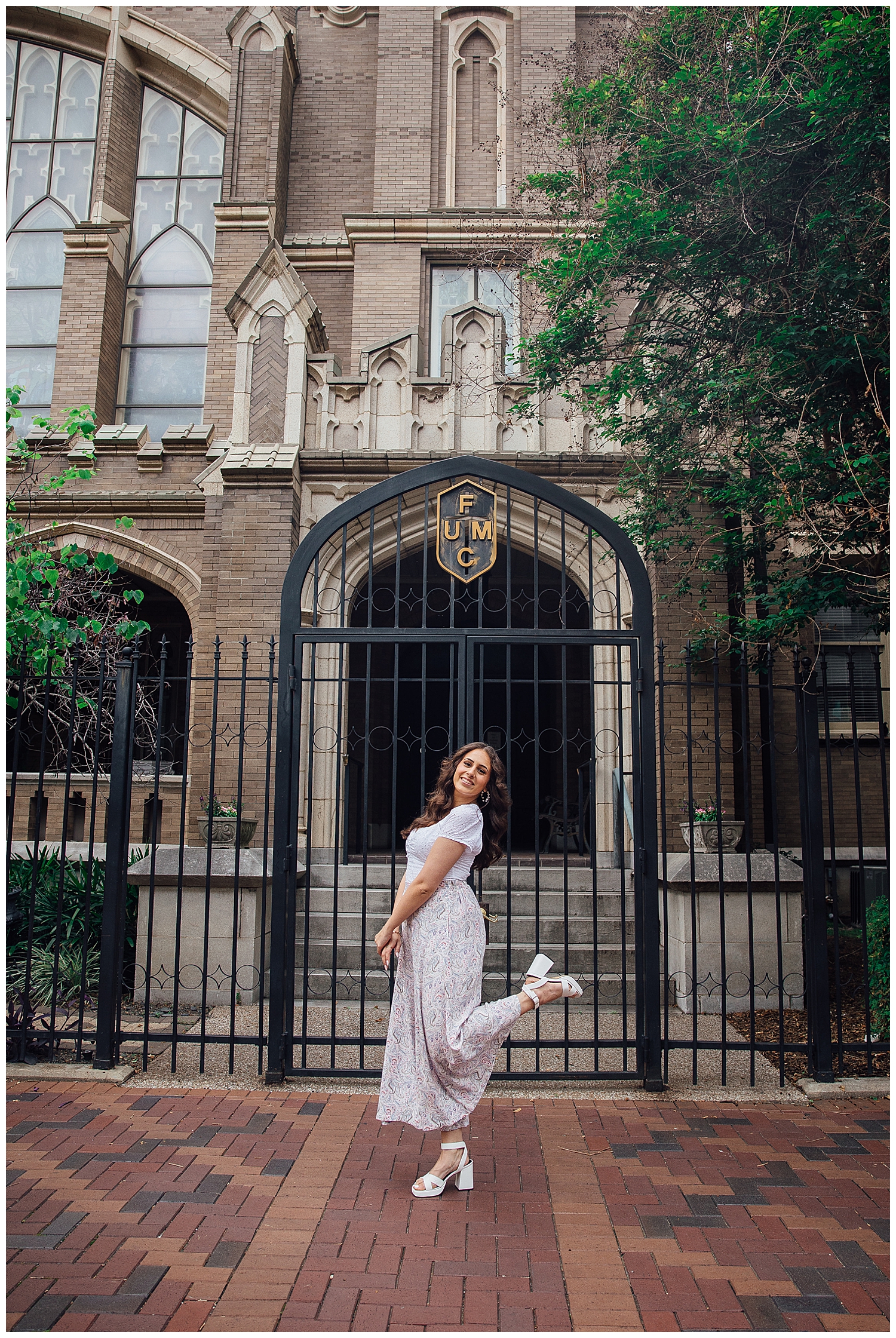 Senior girl posing with heel in air in front of church on Main Street downtown Houston