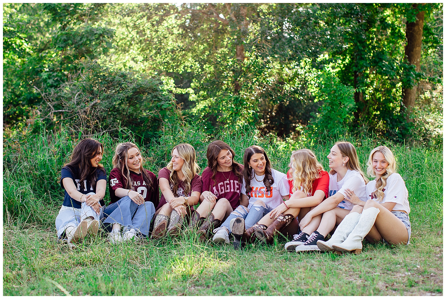Reed Gallagher Photography senior rep team in college shirts sitting under a tree
