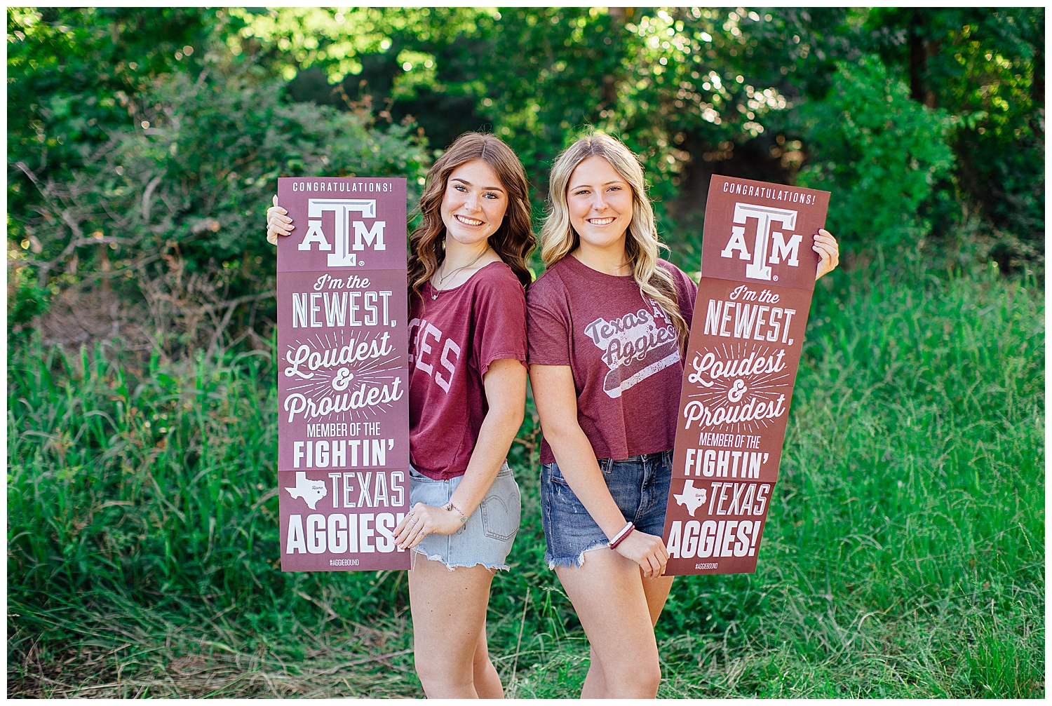 sisters facing camera holding Aggie signs outdoors in Houston