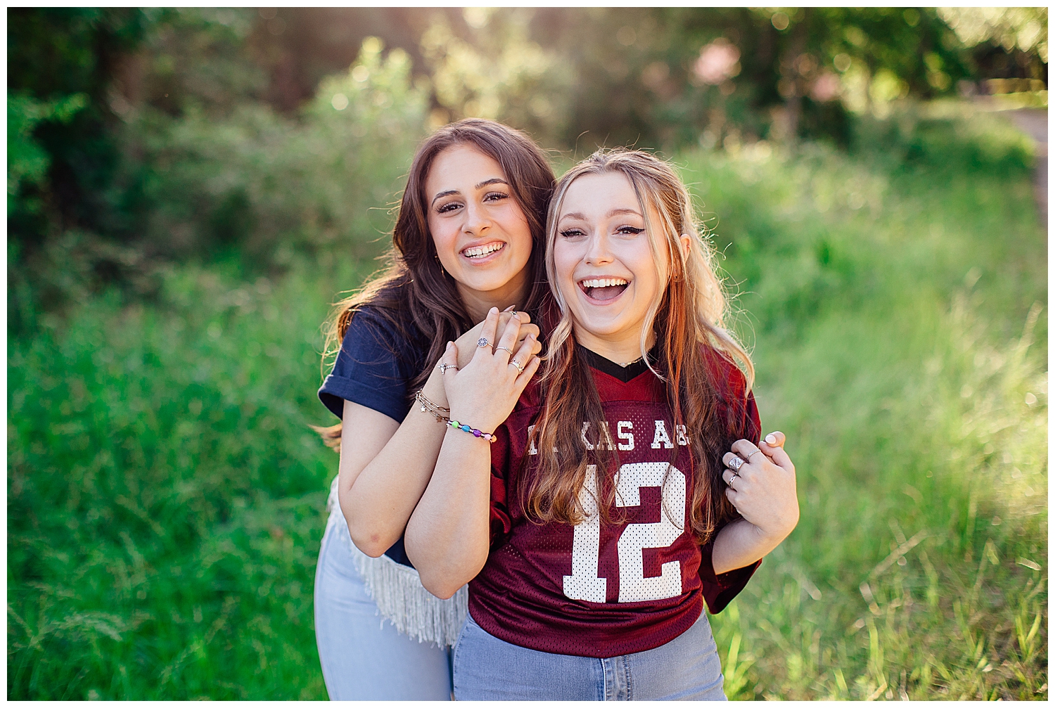 best friends holding hands and laughing for college shirt senior photos
