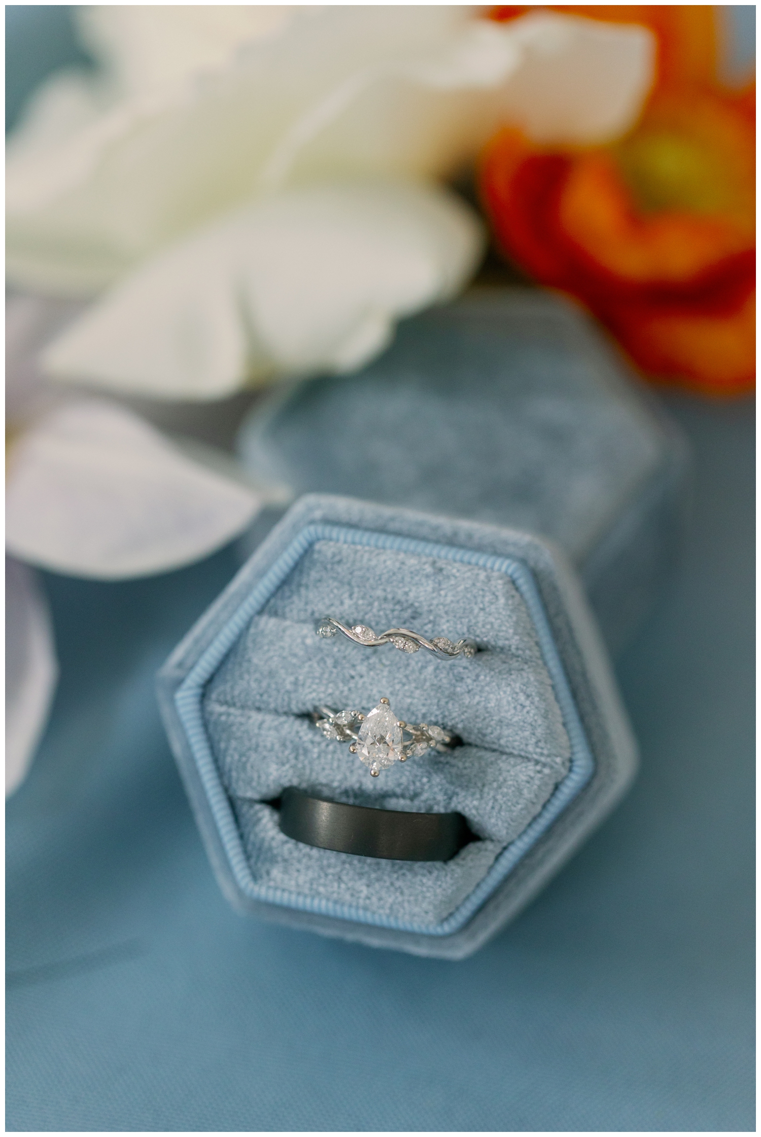baby blue ring box surrounded by white florals