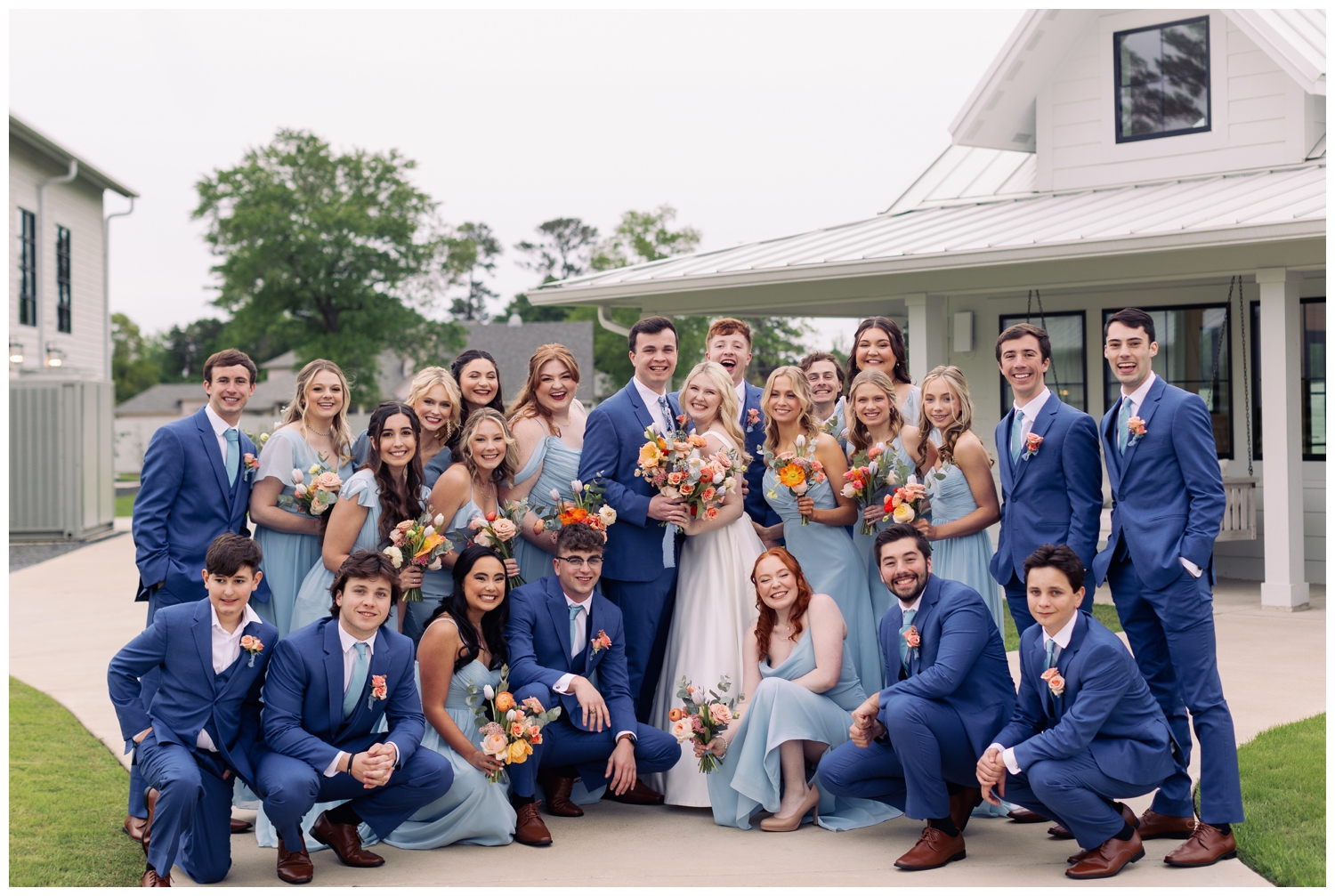 full bridal party in blue outdoors for Boxwood Manor Wedding venue