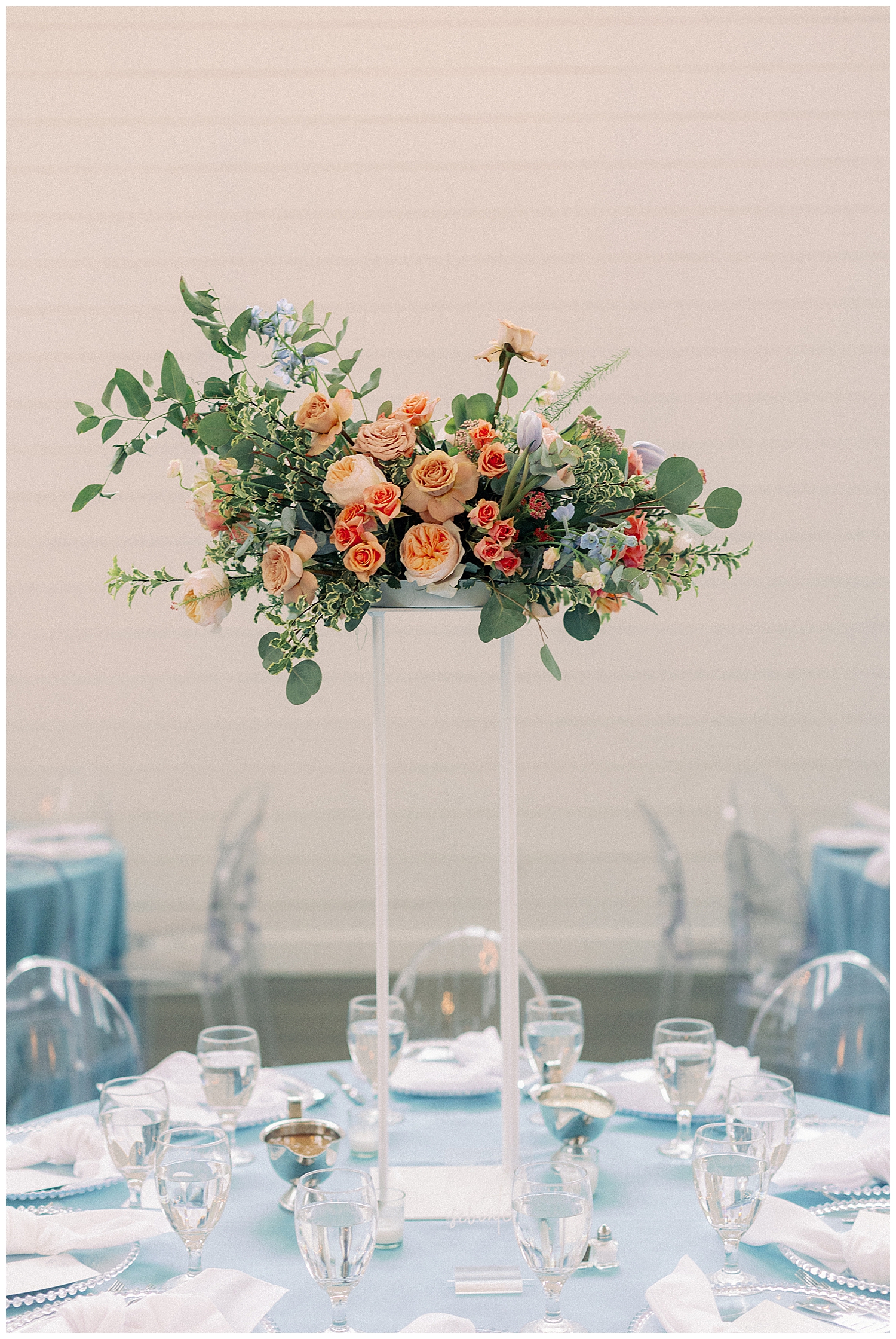 tall coral and peach centerpiece on reception table