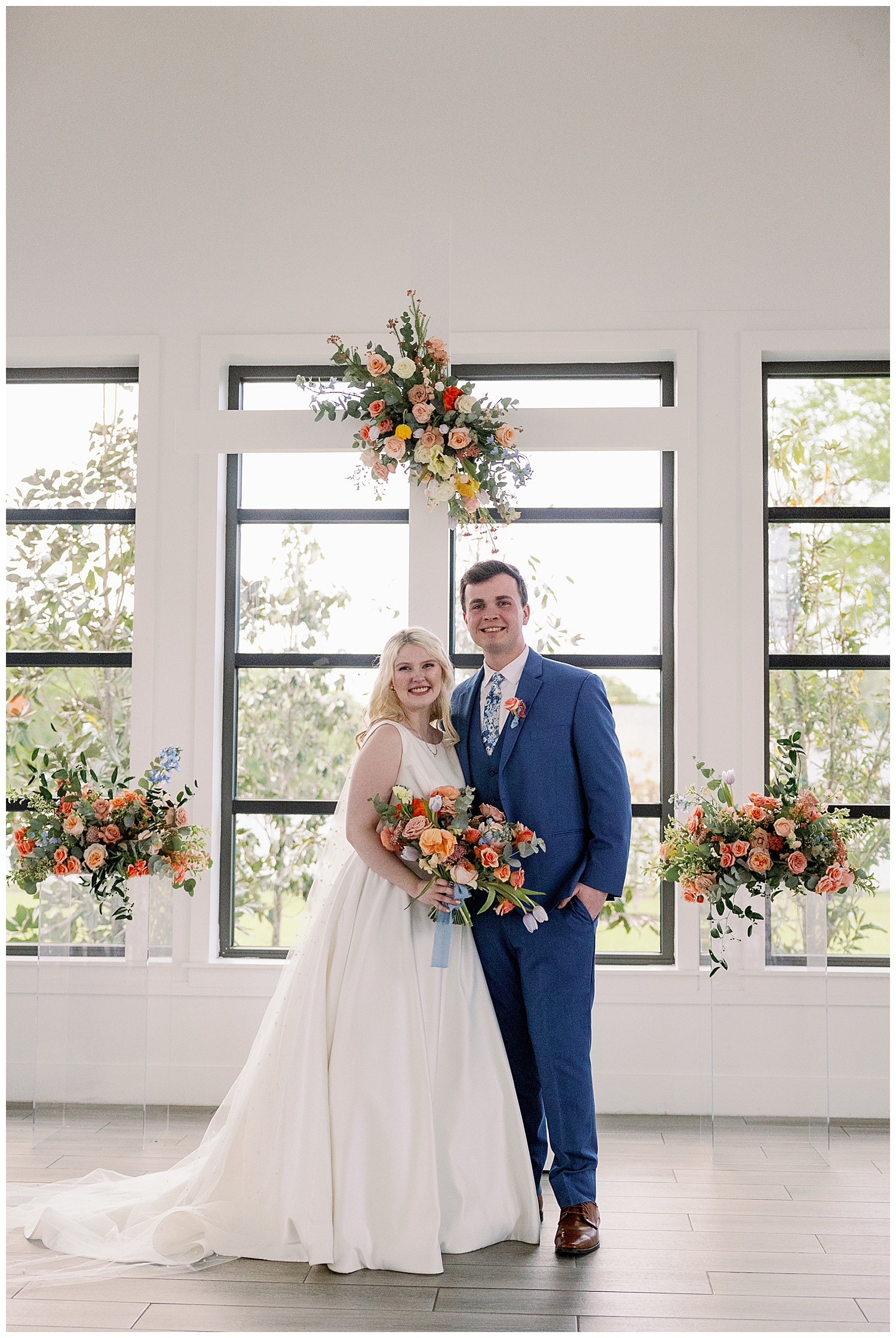 Boxwood Manor chapel with bride and groom and bouquet portrait under the cross