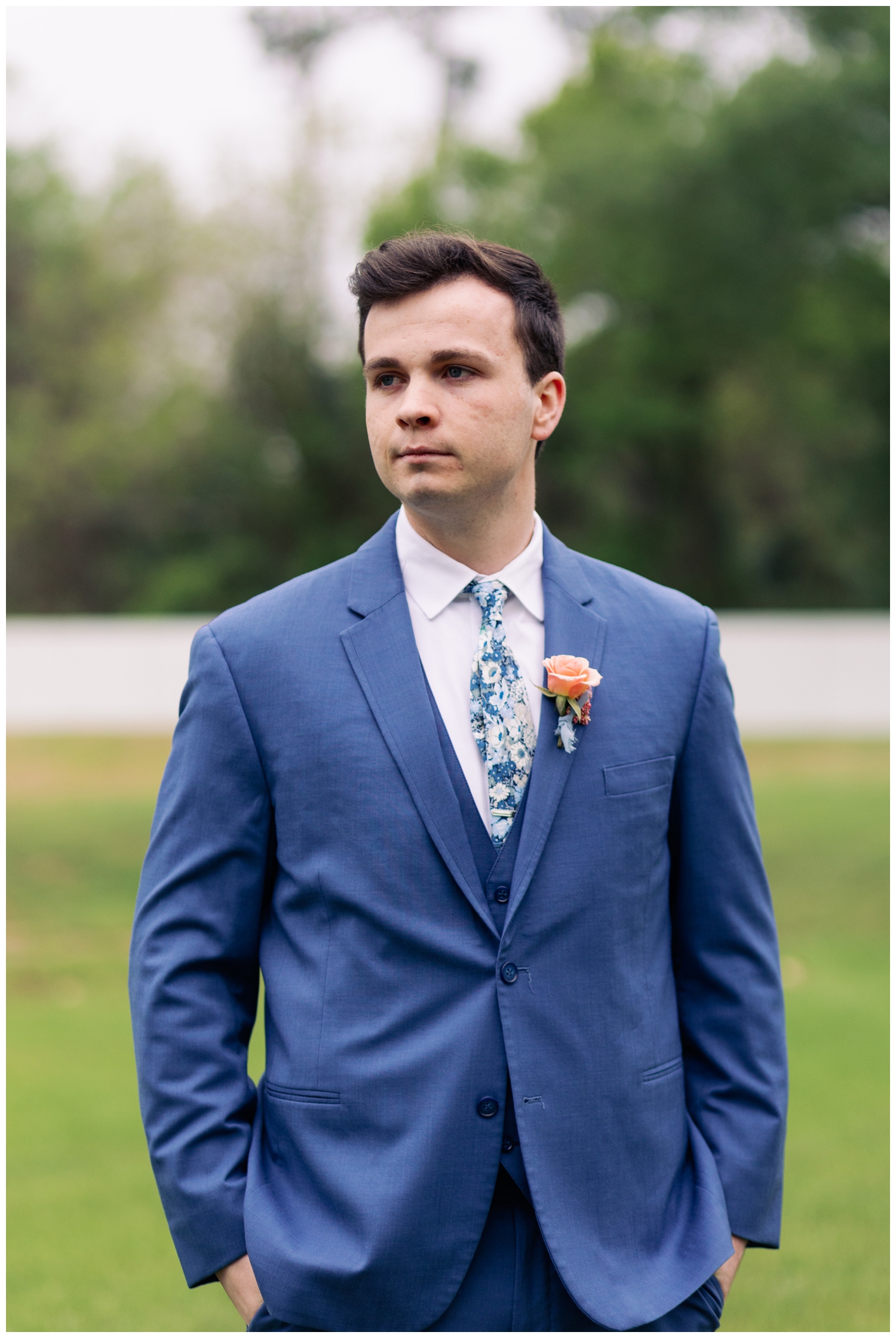 groom in blue suit walking outdoors