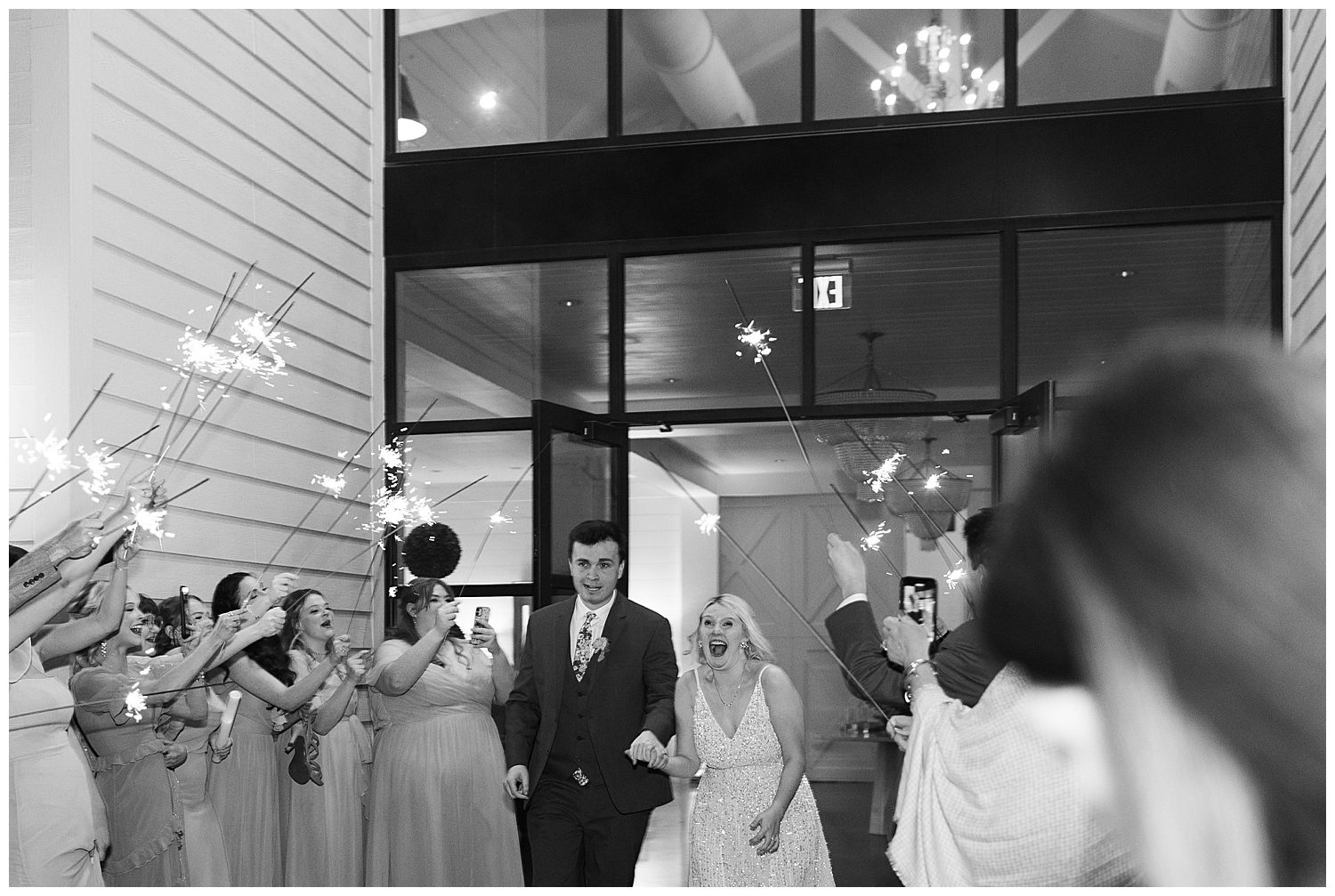 black and white image of bride and groom sparkler exit