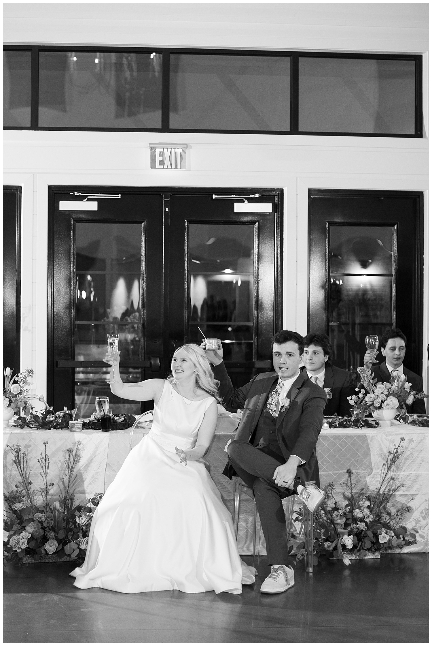 black and white image of bride and groom toasting at Tomball texas reception
