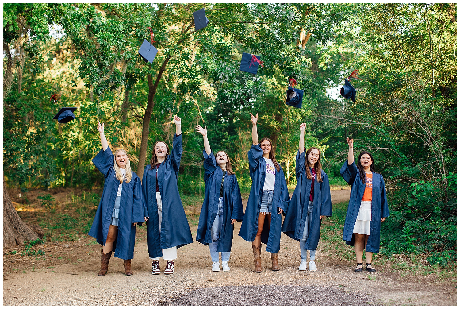 high school Houston rep team throwing cap in the air for cap and gown senior pictures