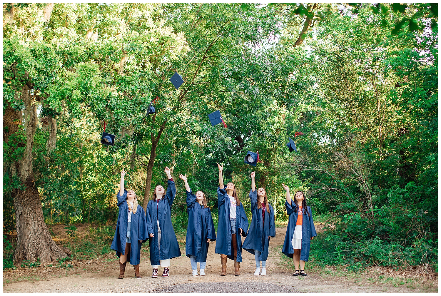 cap and gown senior pictures with group of girls throwing cap in air Houston, Texas