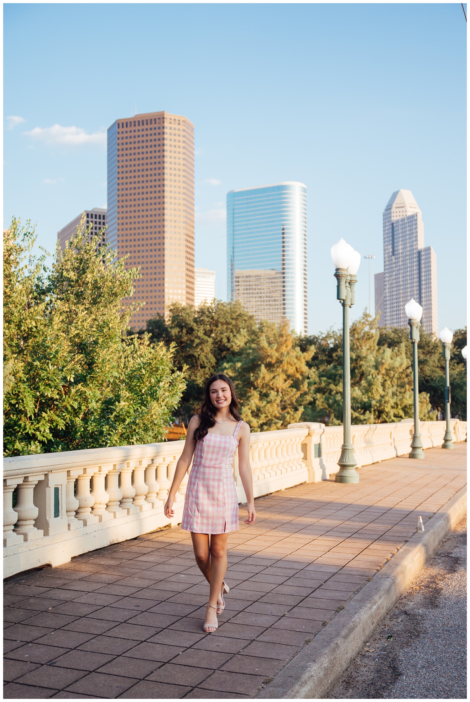 senior photos Houston Skyline sabine street bridge girl walking white dress