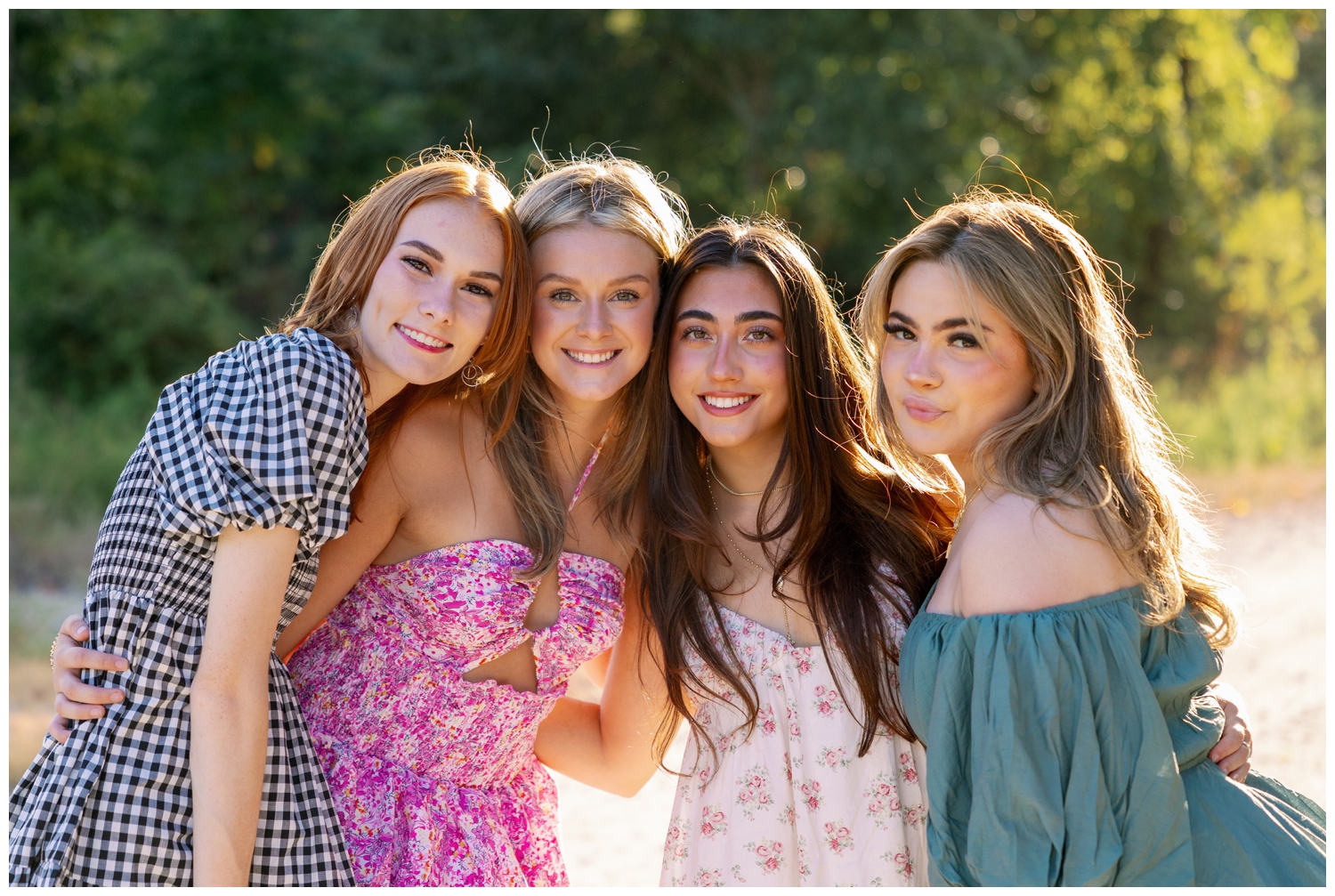 close up image of four girls in sundresses smiling for senior rep team Houston