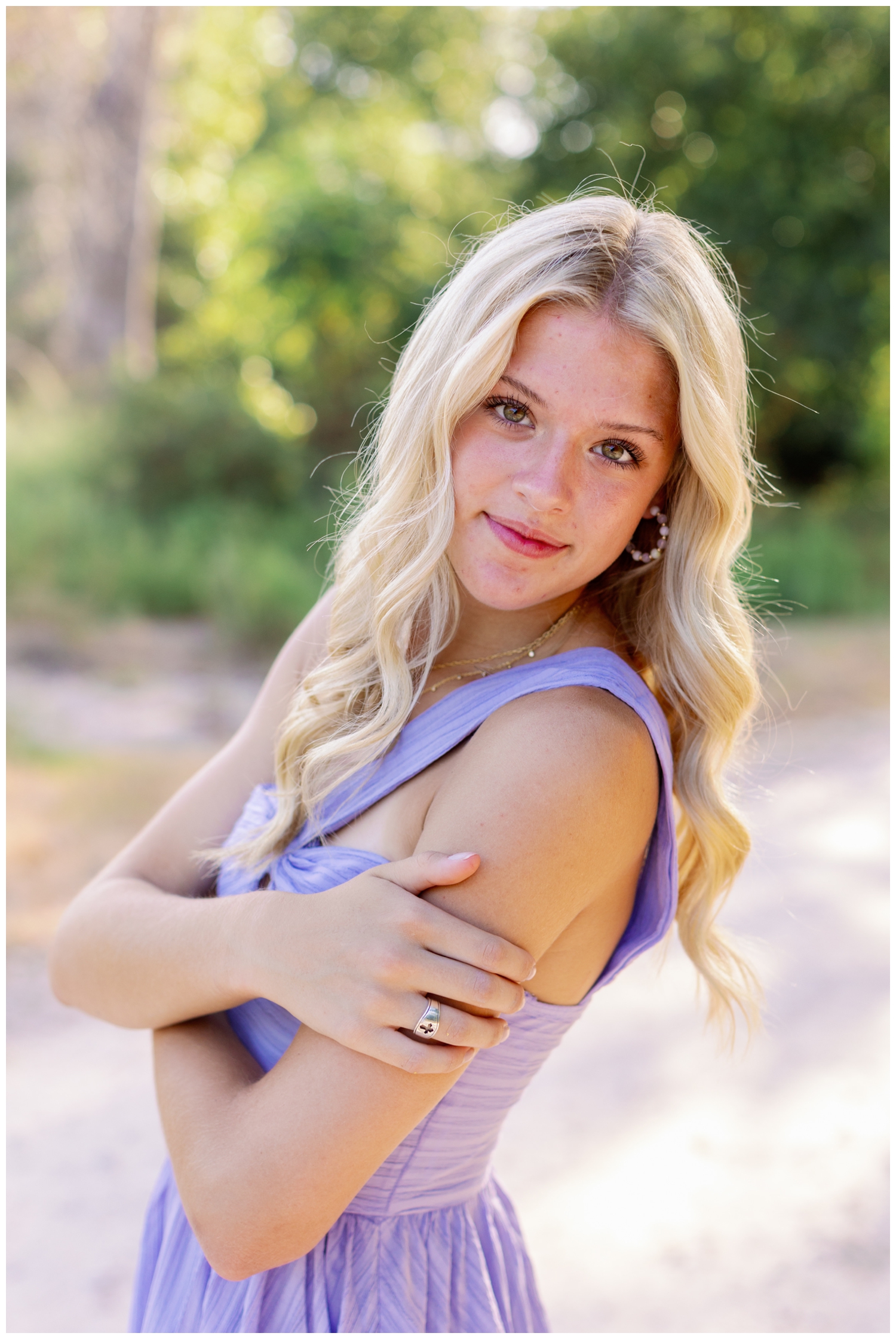 high school senior girl in lavender dress smiling for Reed Gallagher Photography