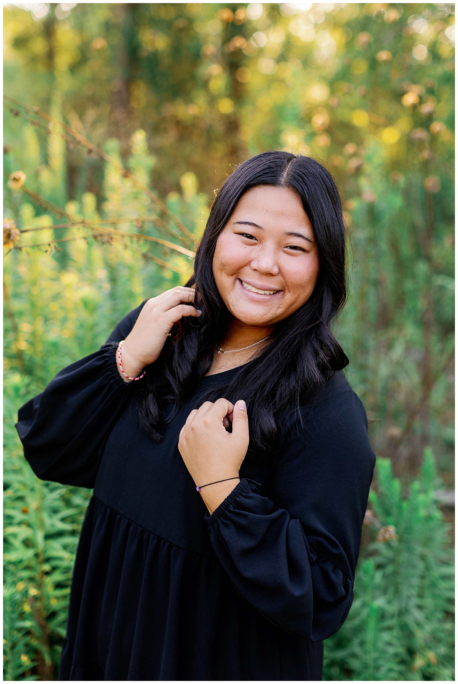 closeup image of a girl smiling with hand in hair outdoors for Houston Arboretum senior session
